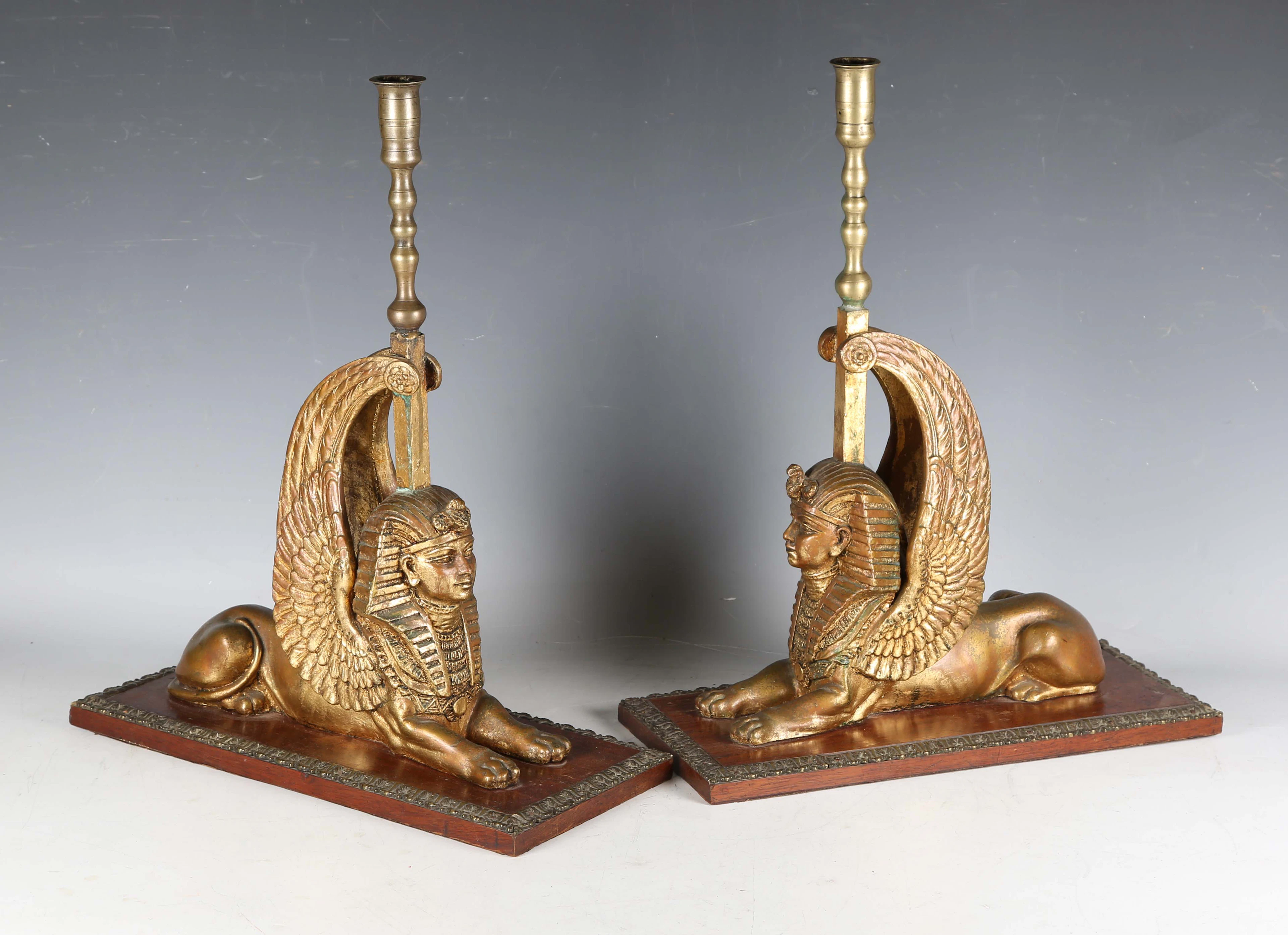 A pair of 20th century Egyptianesque gilt composition candle stands
