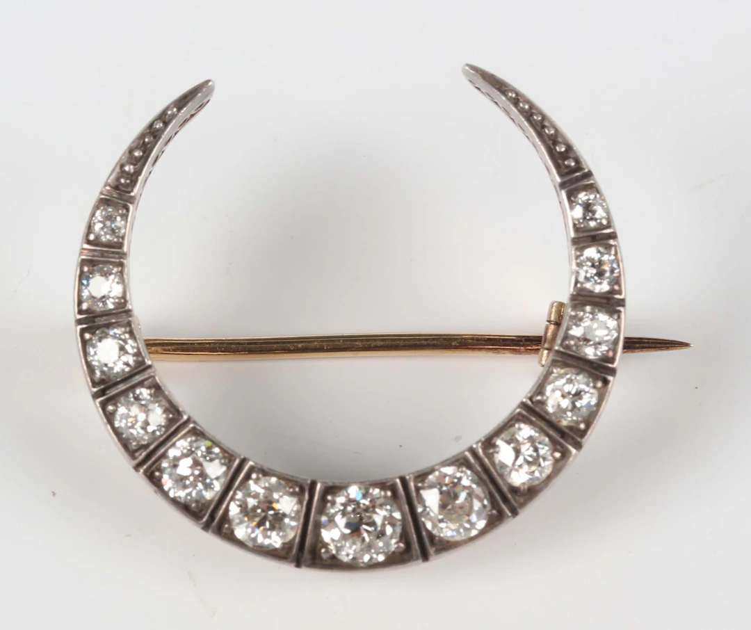 A Victorian gold backed, silver set and diamond brooch, designed as