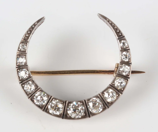 A Victorian gold backed, silver set and diamond brooch, designed as