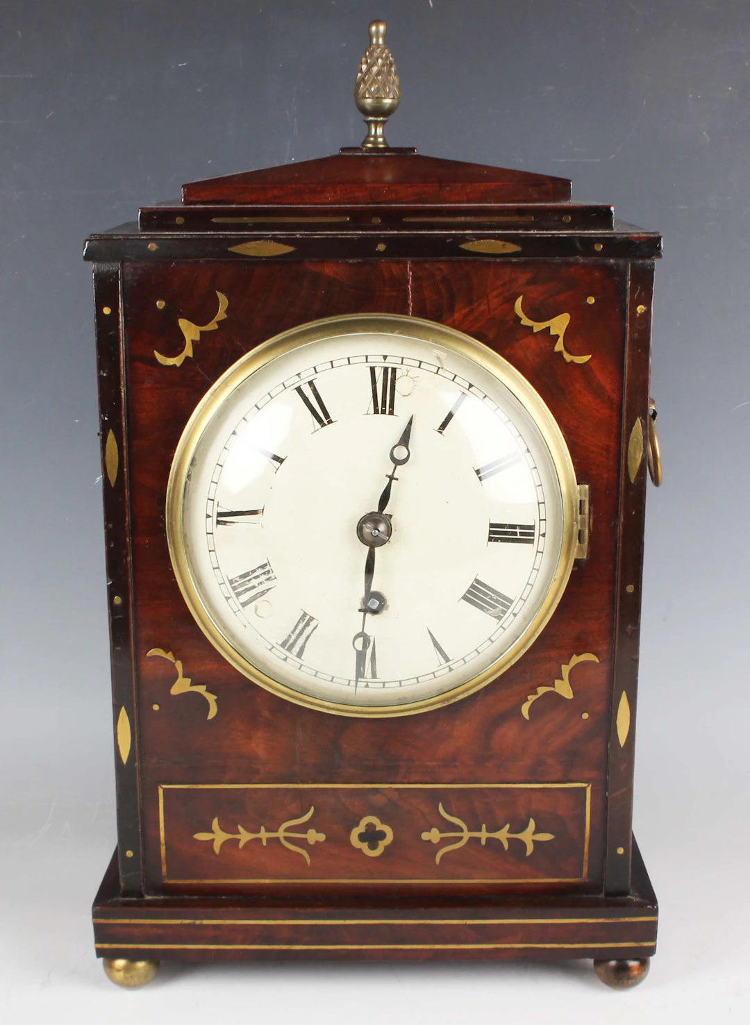 A Regency brass mounted and inlaid mahogany cased bracket timepiece