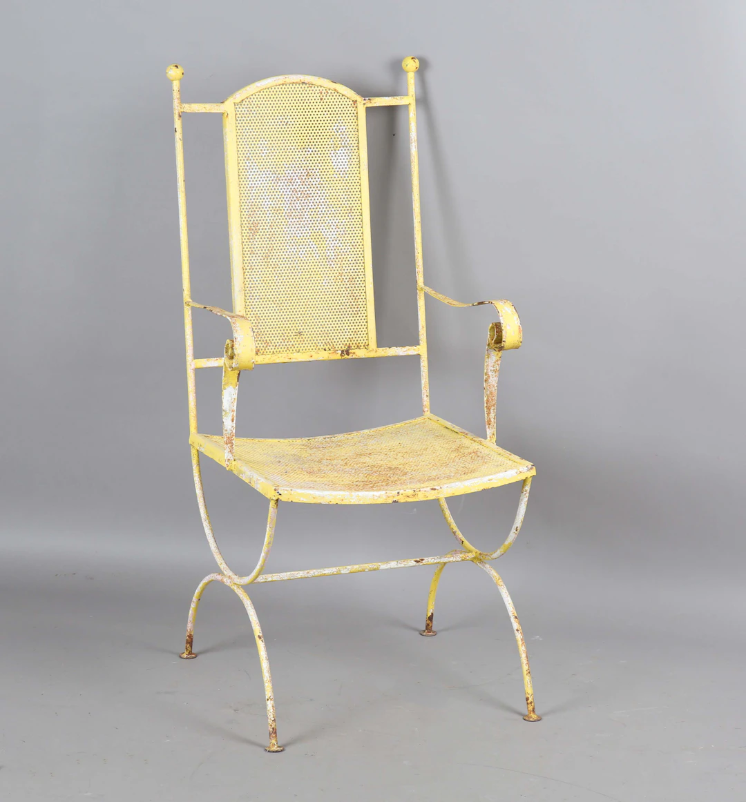 A 20th century yellow painted wrought iron garden armchair, height
