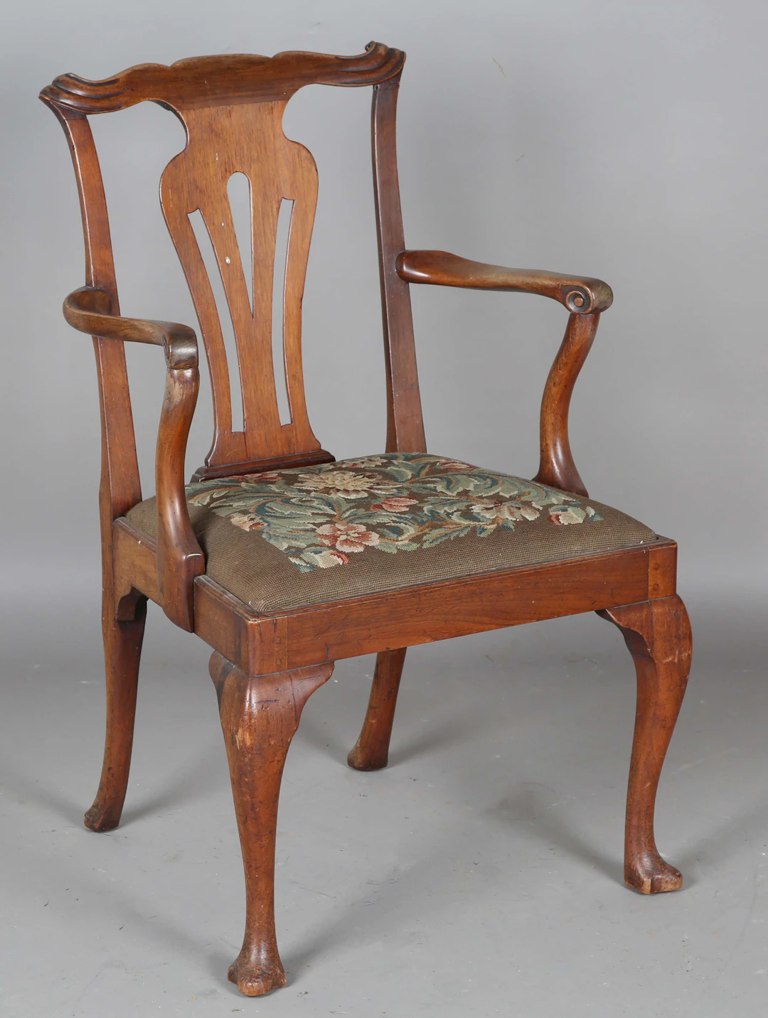 A George II red walnut pierced splat back elbow chair, height 95cm