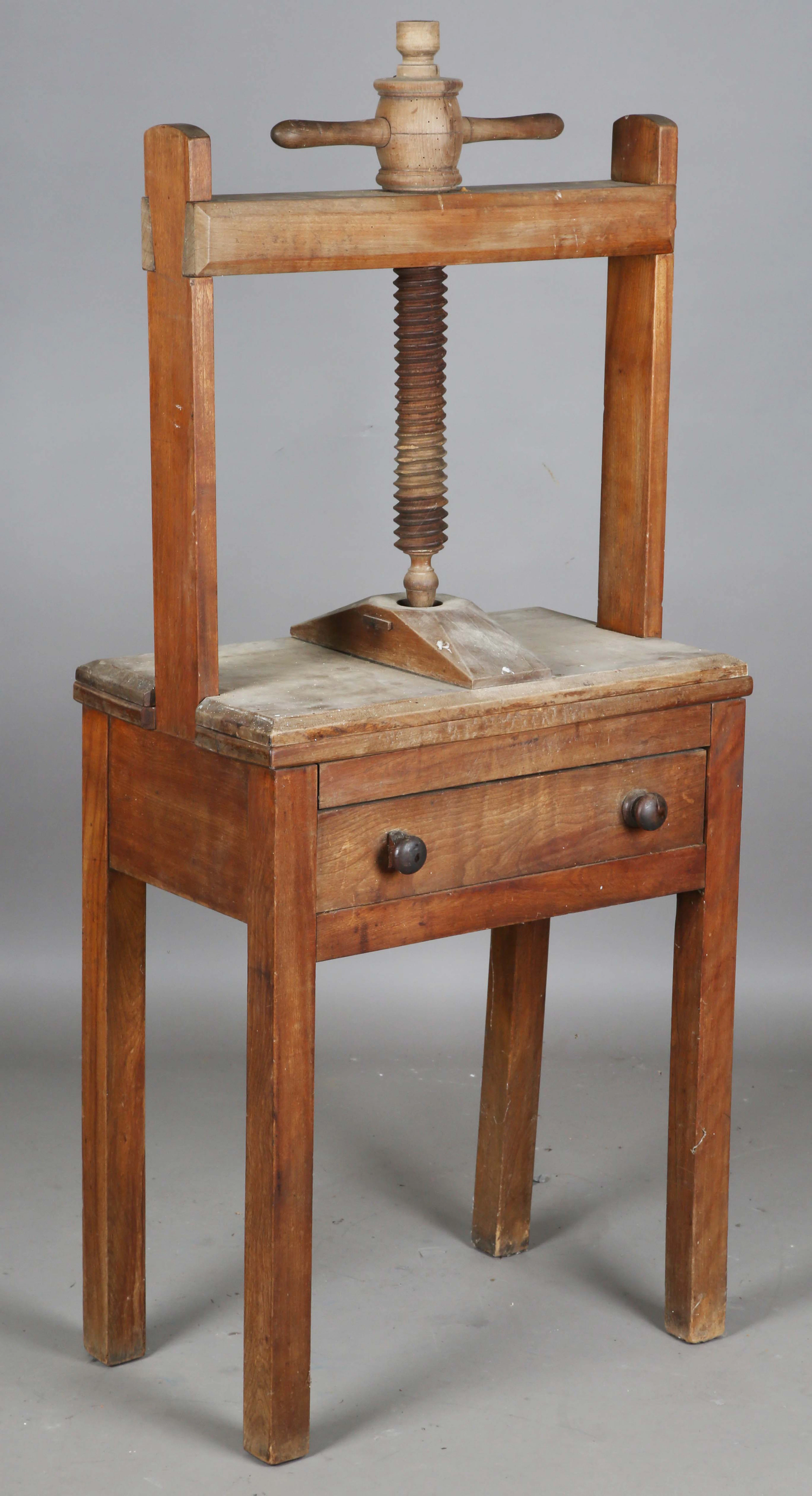 An early Victorian provincial fruitwood bookpress with table stand