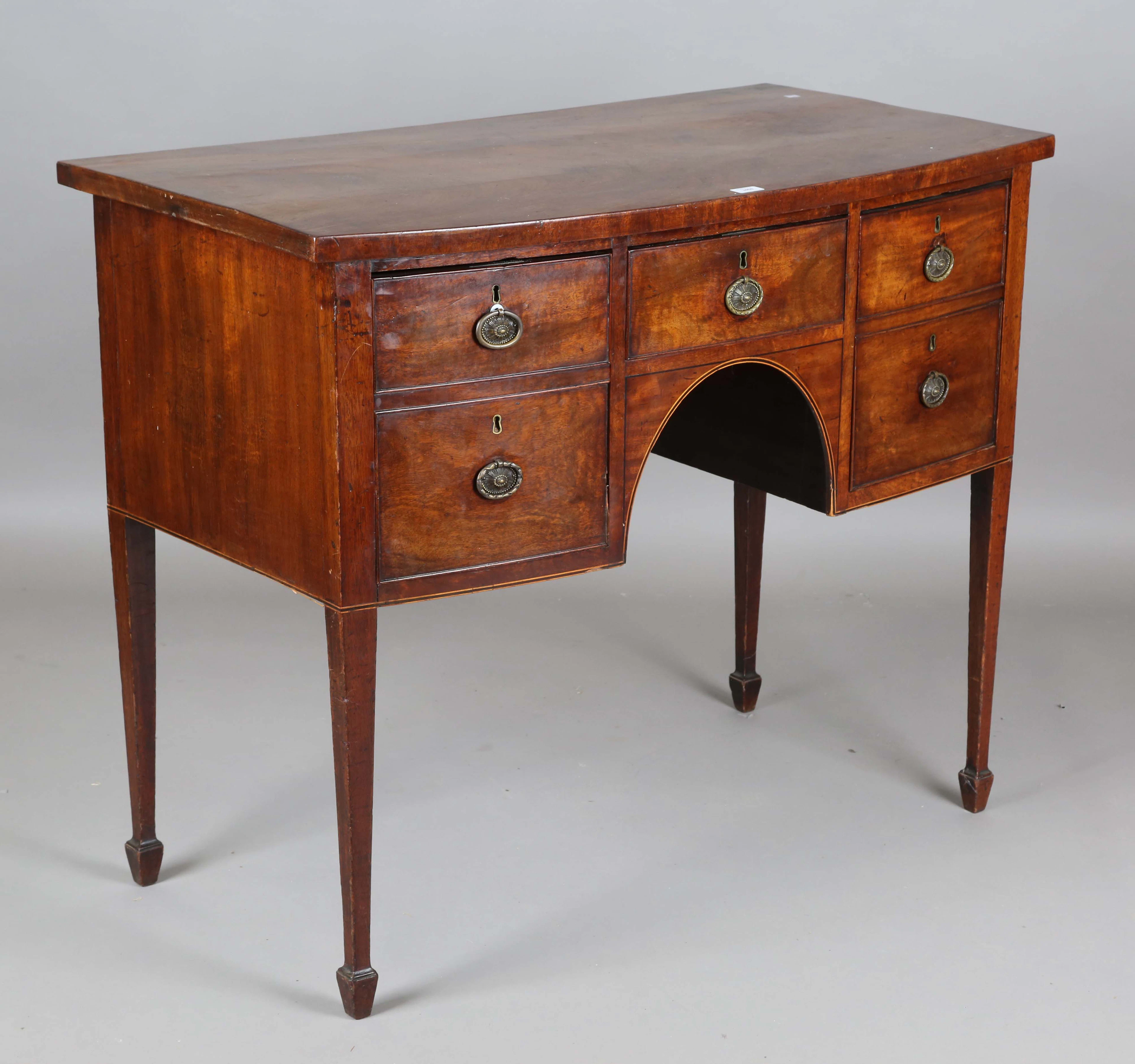 A George III mahogany bowfront sideboard, fitted with three oak-lined