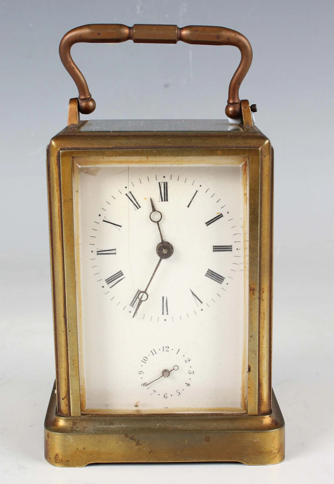 A late 19th century French brass one piece cased carriage alarm clock