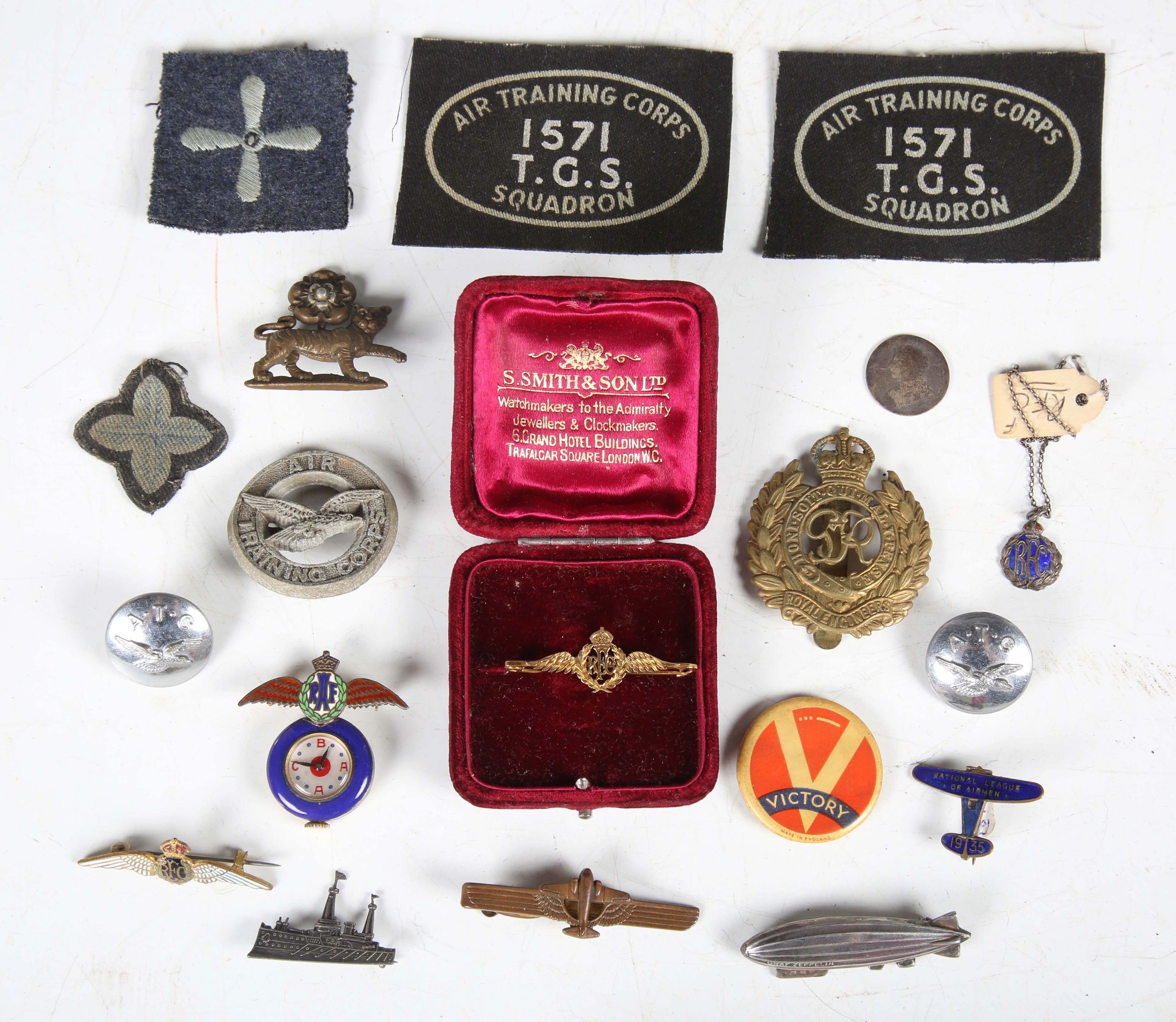 A small collection of military badges and associated items, including