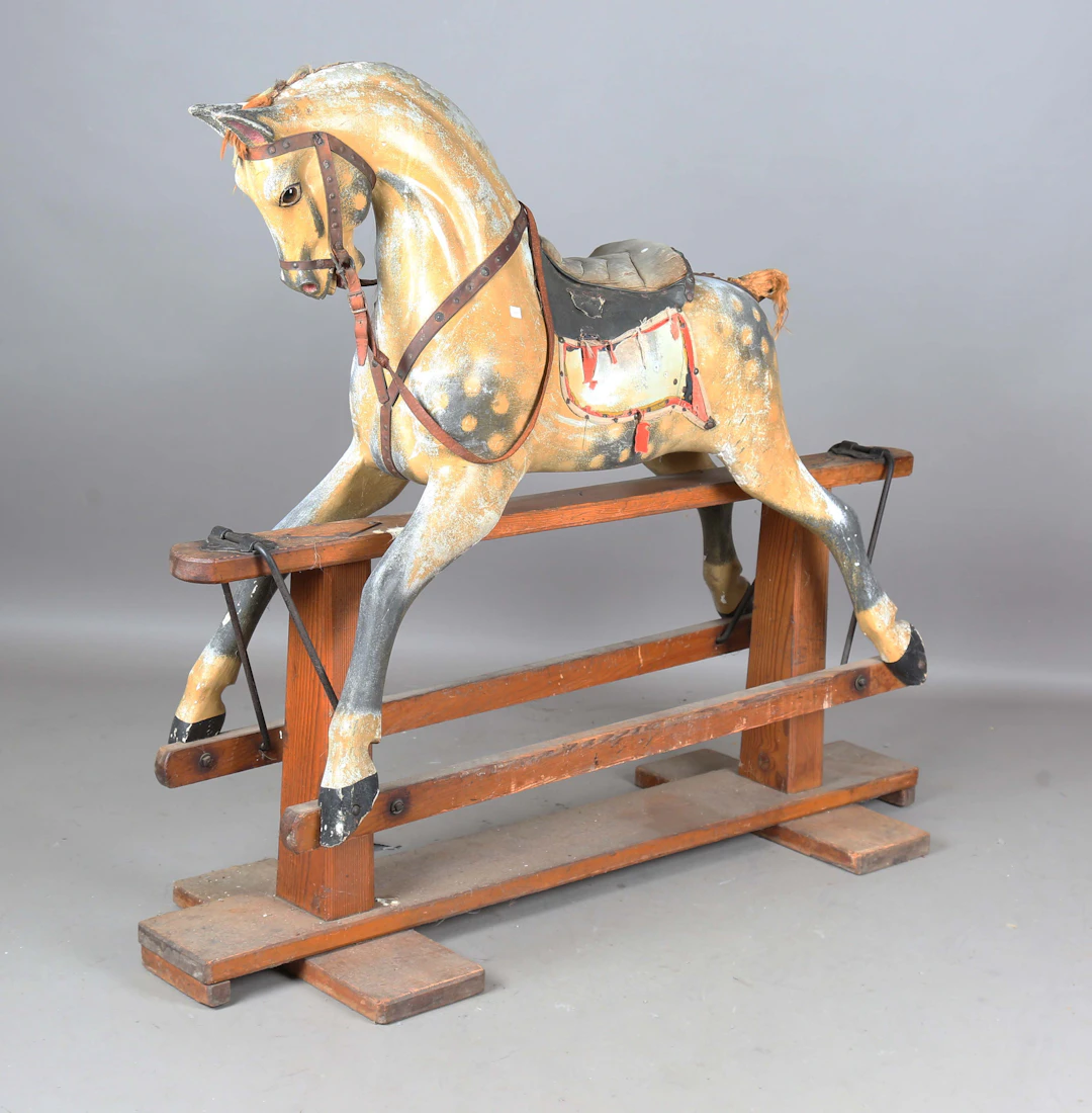 A large Victorian carved wooden and dapple grey painted rocking horse