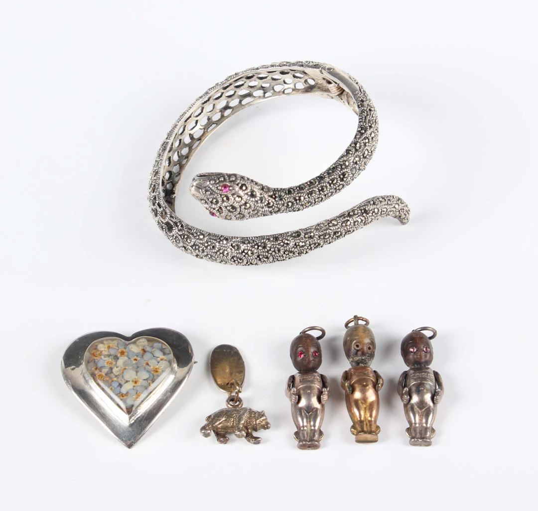 A silver, marcasite and red paste set circular hinged bangle in the
