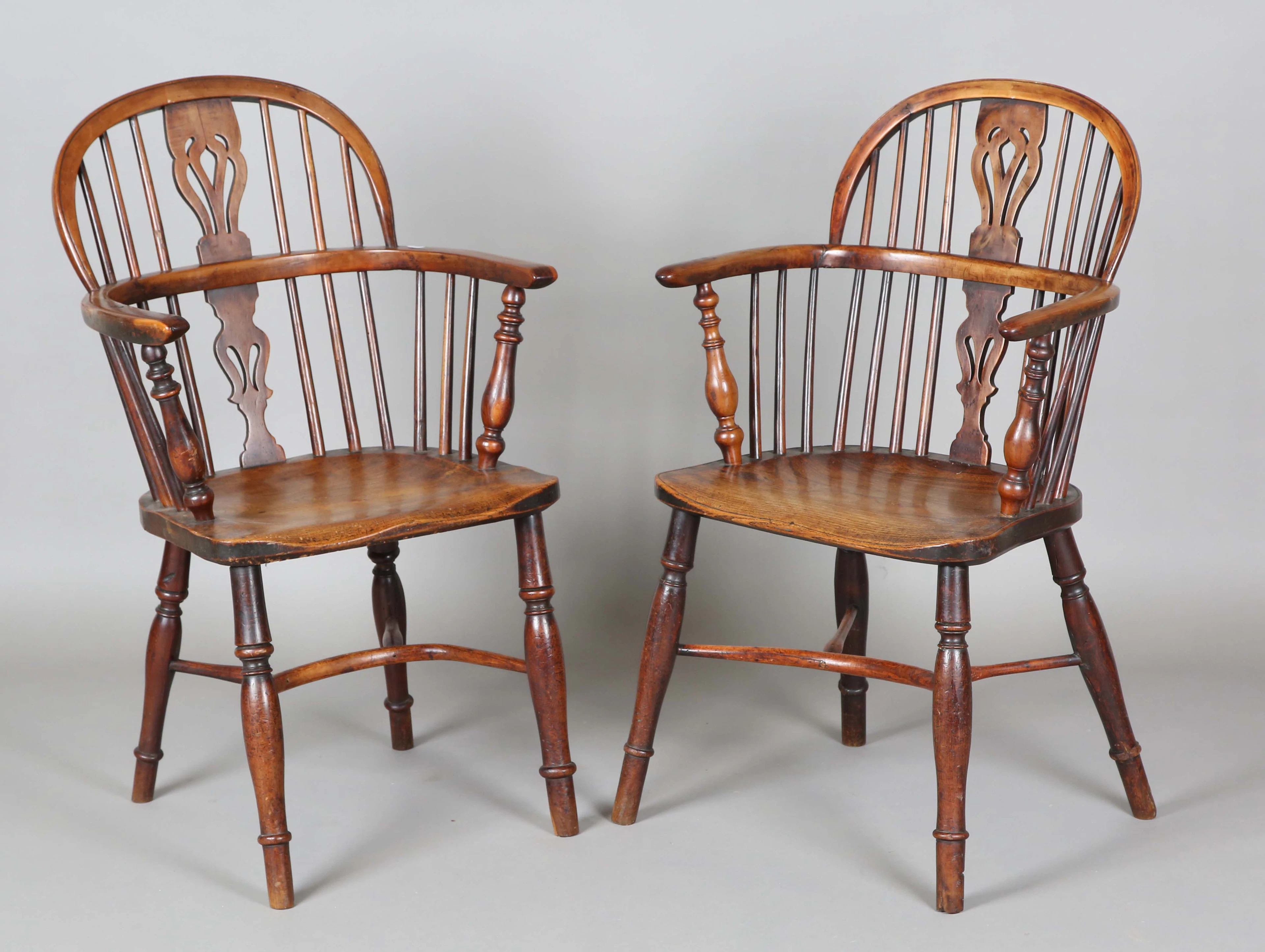 A near pair of early Victorian yew wood and elm pierced splat back