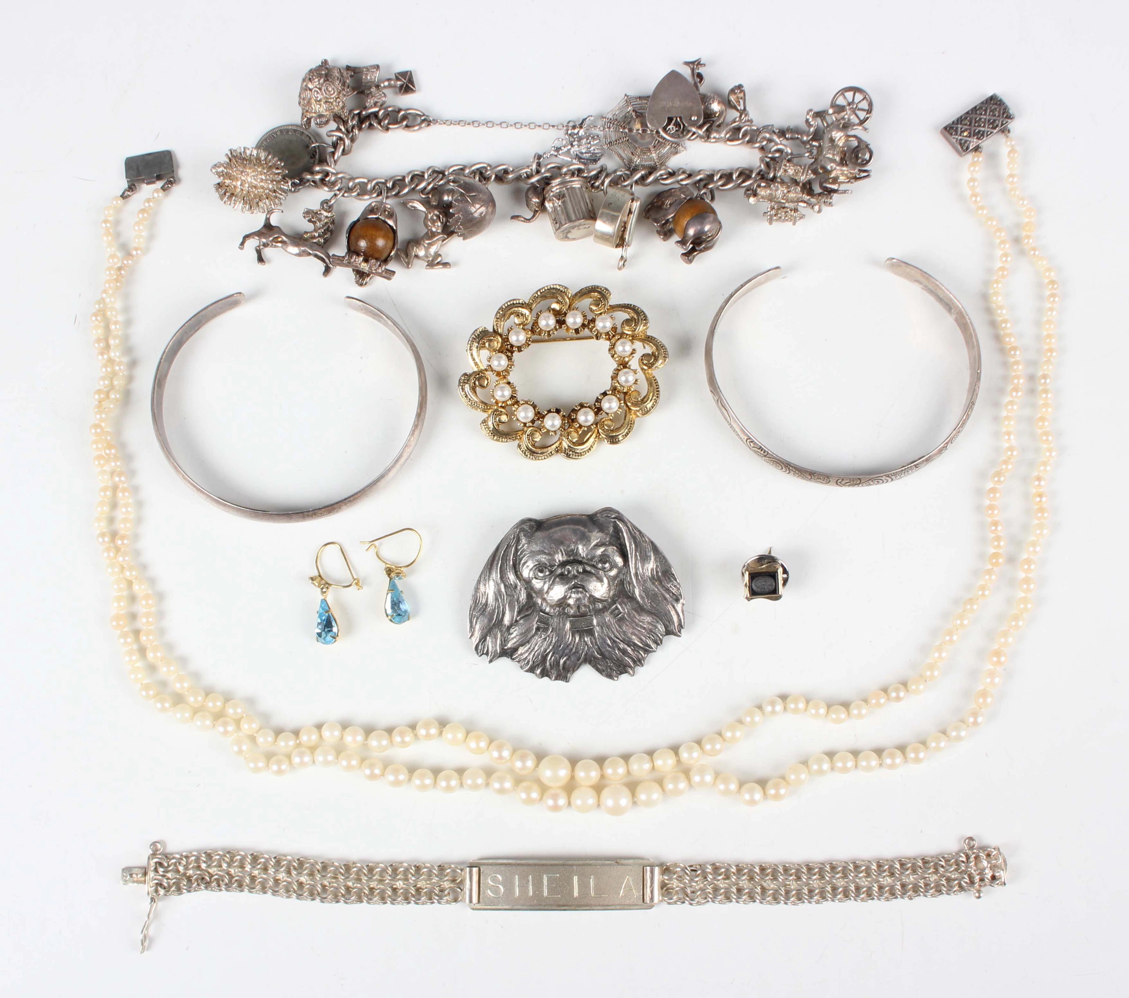 A group of mostly silver jewellery, including a charm bracelet, fitted