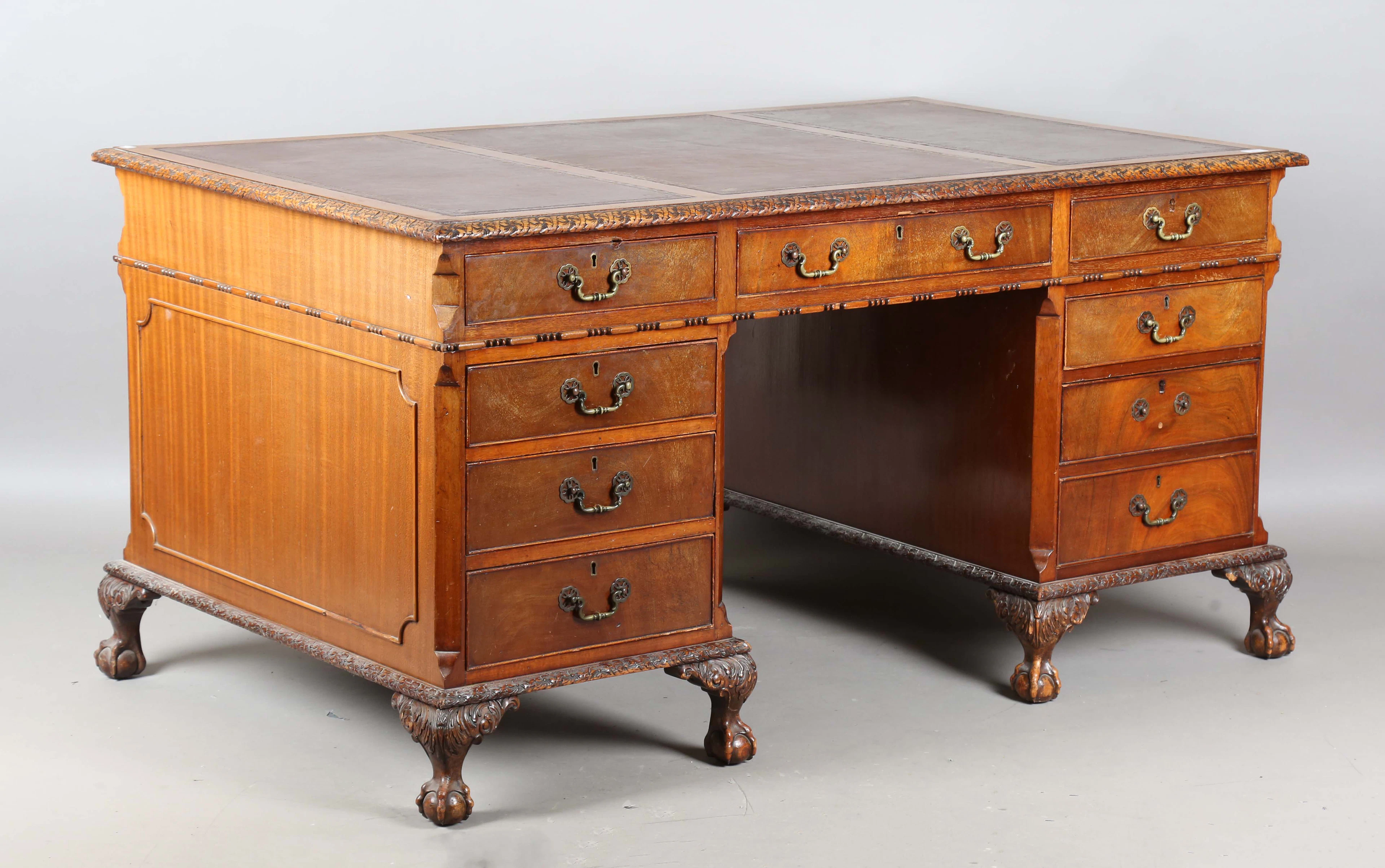 An early 20th century reproduction mahogany twin-pedestal desk, the