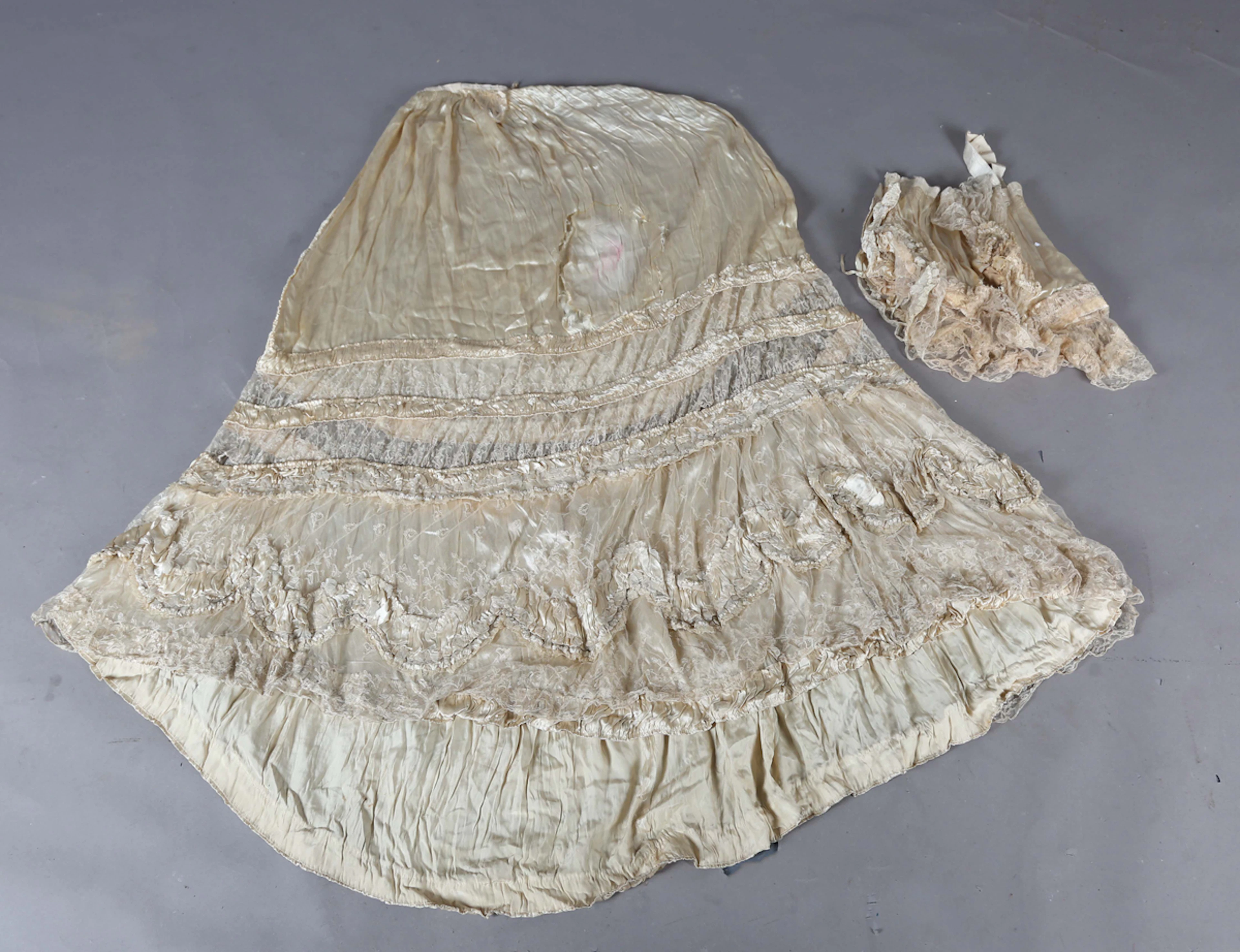 A Victorian cream silk and applied lace bodice with boned waist, together