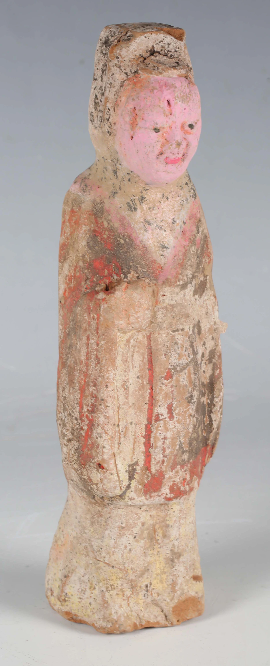 A Chinese Tang dynasty moulded terracotta attendant figure, circa