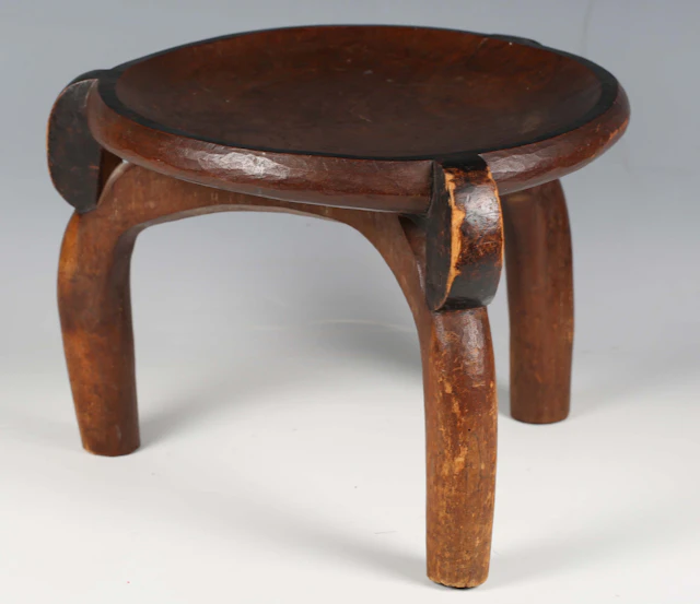 A Hehe carved wooden circular stool, Tanzania, the dished seat raised