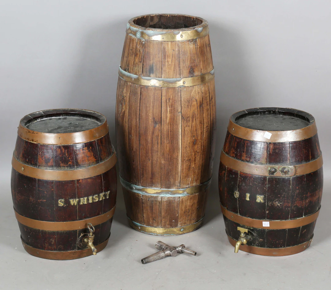 A pair of early 20th century coopered oak barrels, both with applied