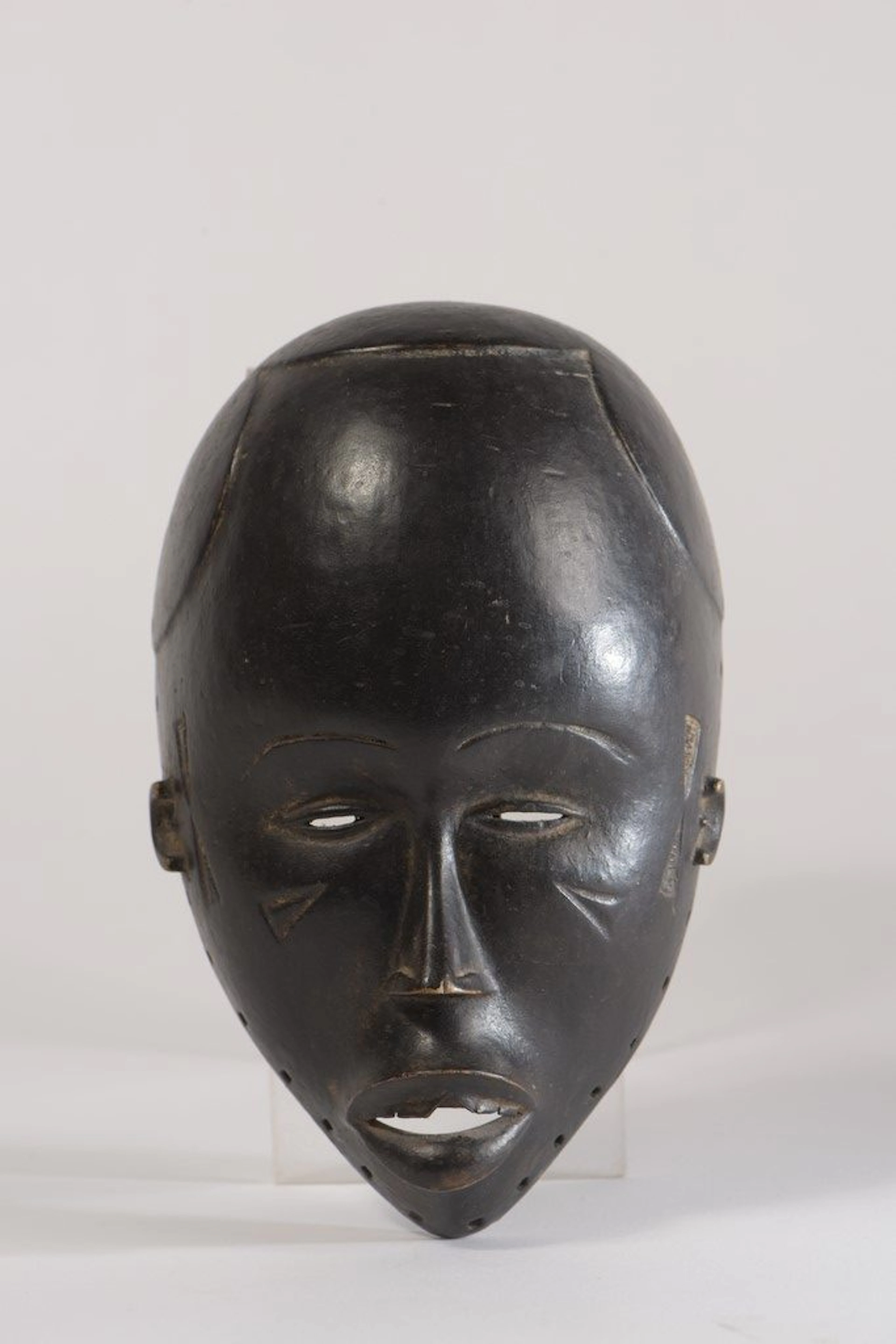 Masque Dan, Côte d'Ivoire. Bois sculpté à patine sombre. La bouche