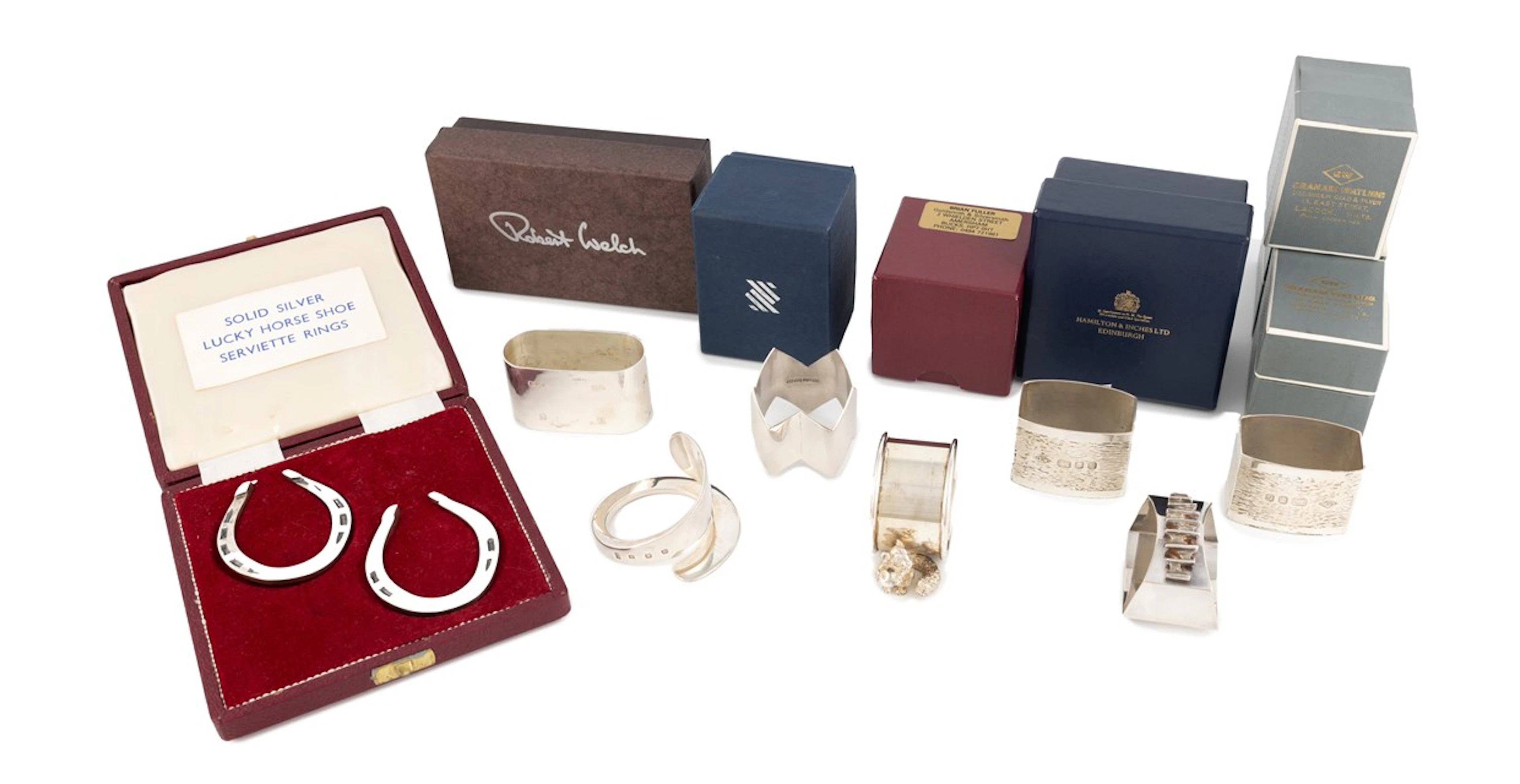 A collection of seven modern silver napkin rings
