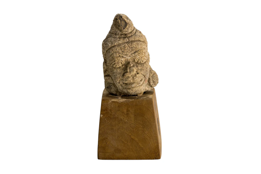 A Southeast Asian carved stone head of Hindu deity