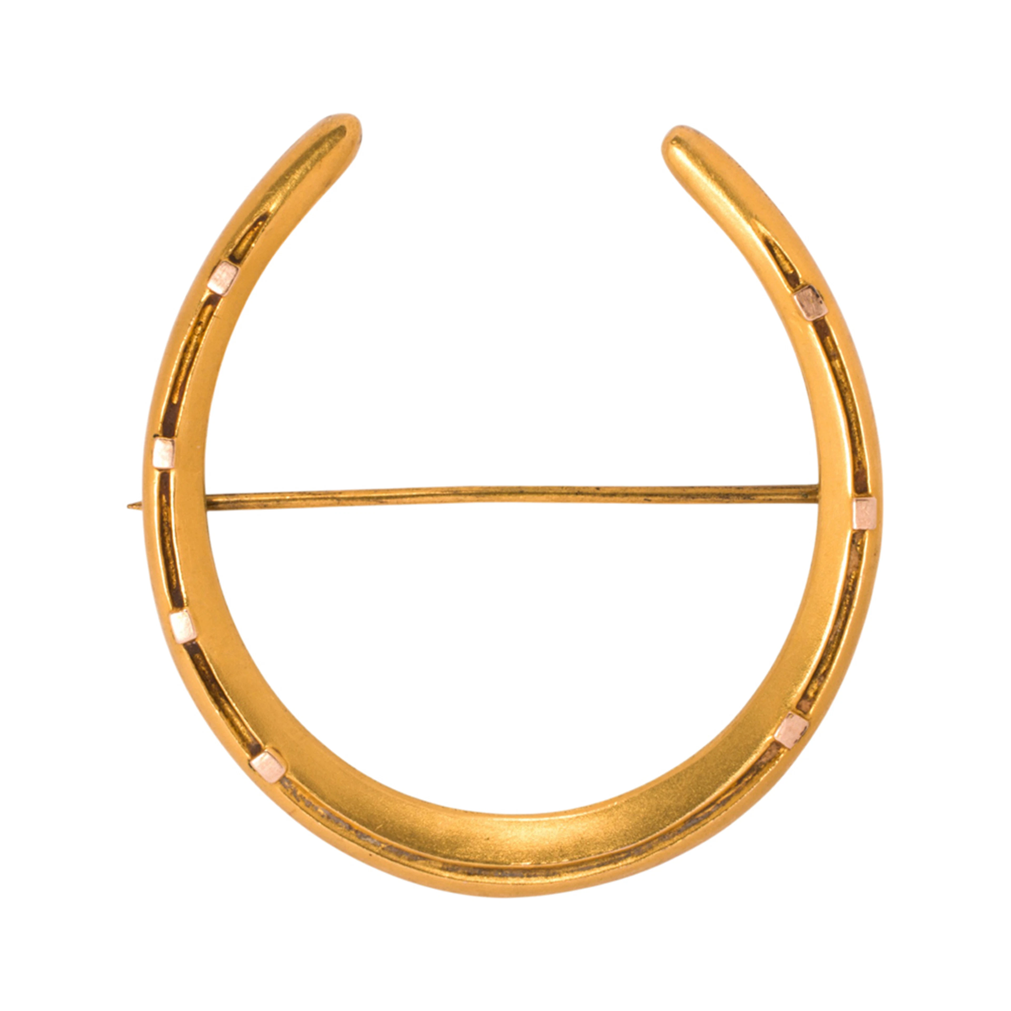 An antique horse shoe brooch