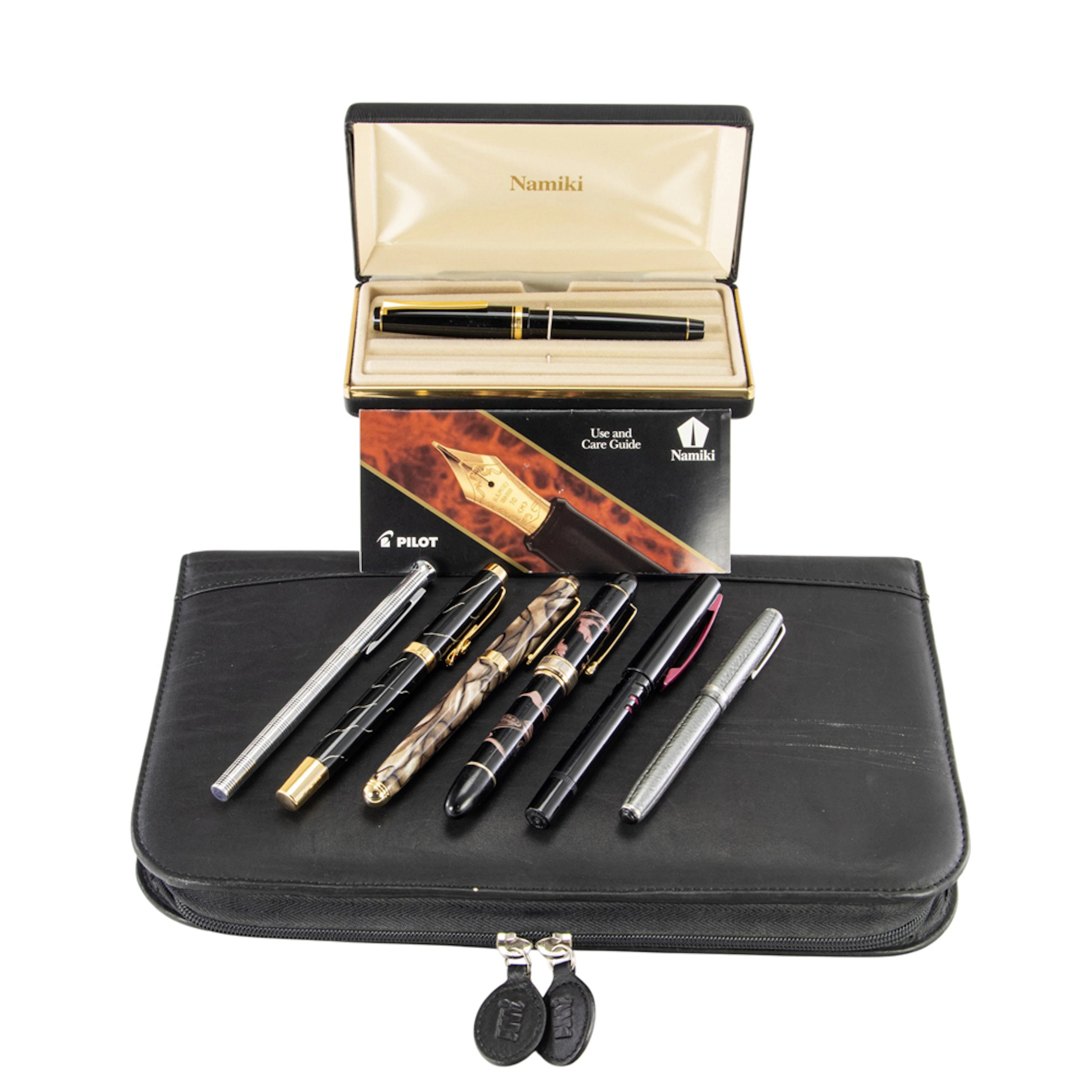 An assembled group of fountain pens with large case