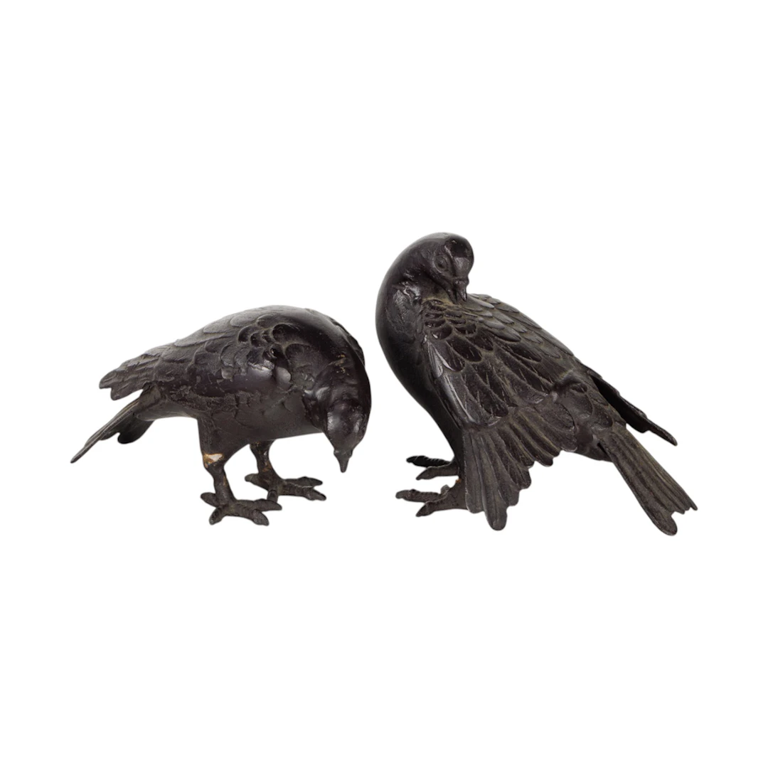 A pair of Japanese patinated bronze figures of pigeons