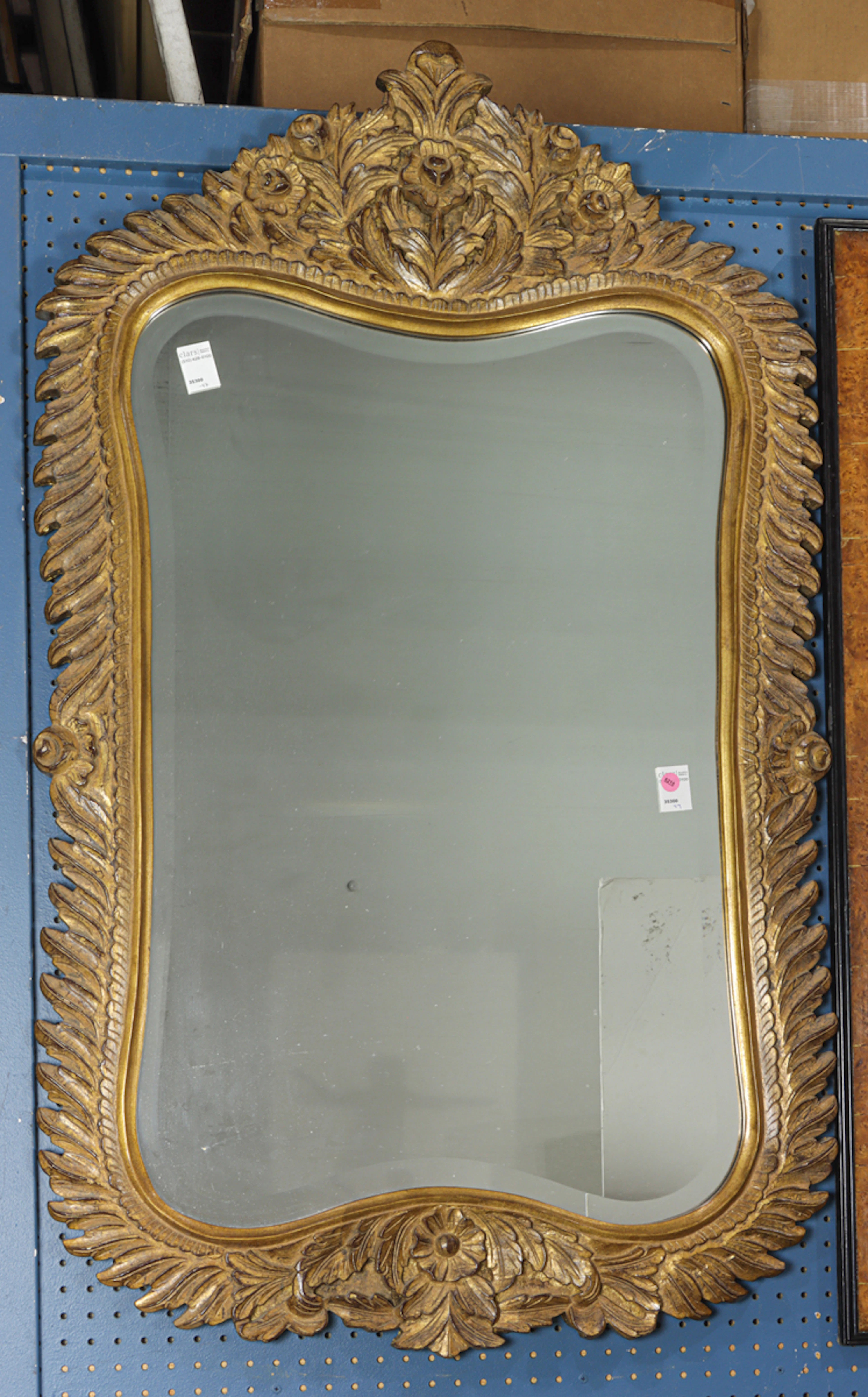 A Spanish Colonial style giltwood carved mirror with beveled mirror plate