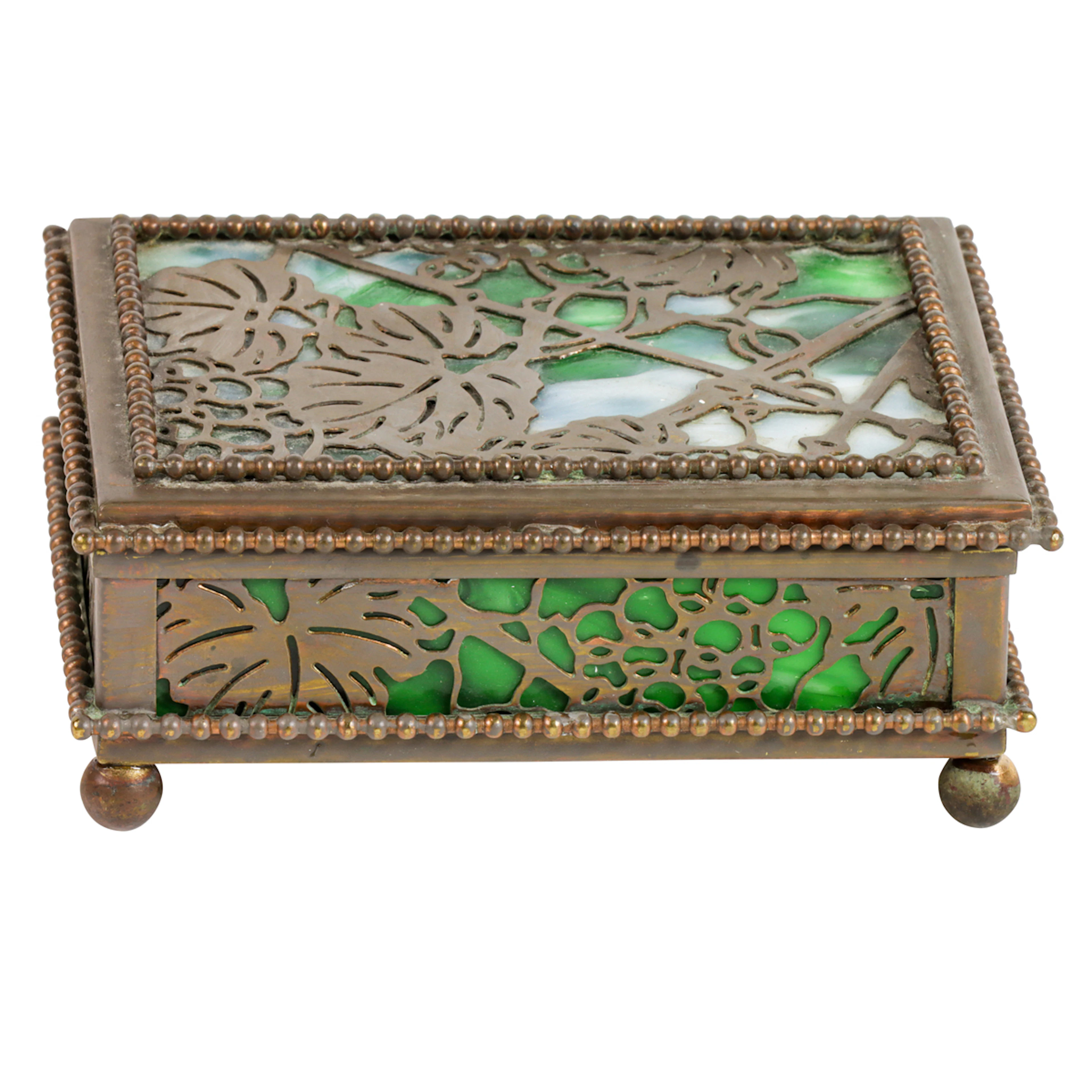 A Tiffany Studios patinated bronze and slag glass Grapevine pattern stamp box