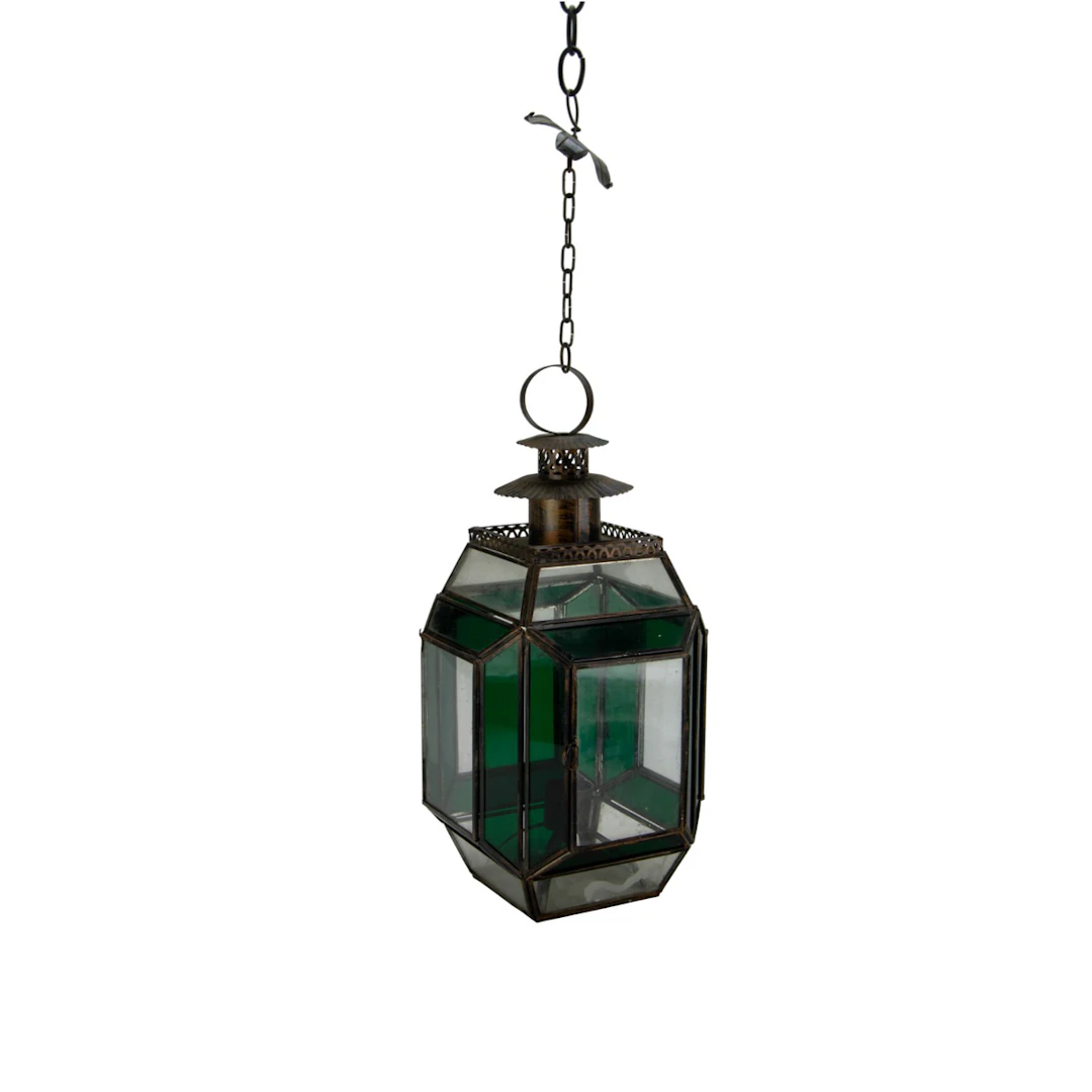 A brass hanging candle lantern with green and clear glass panels