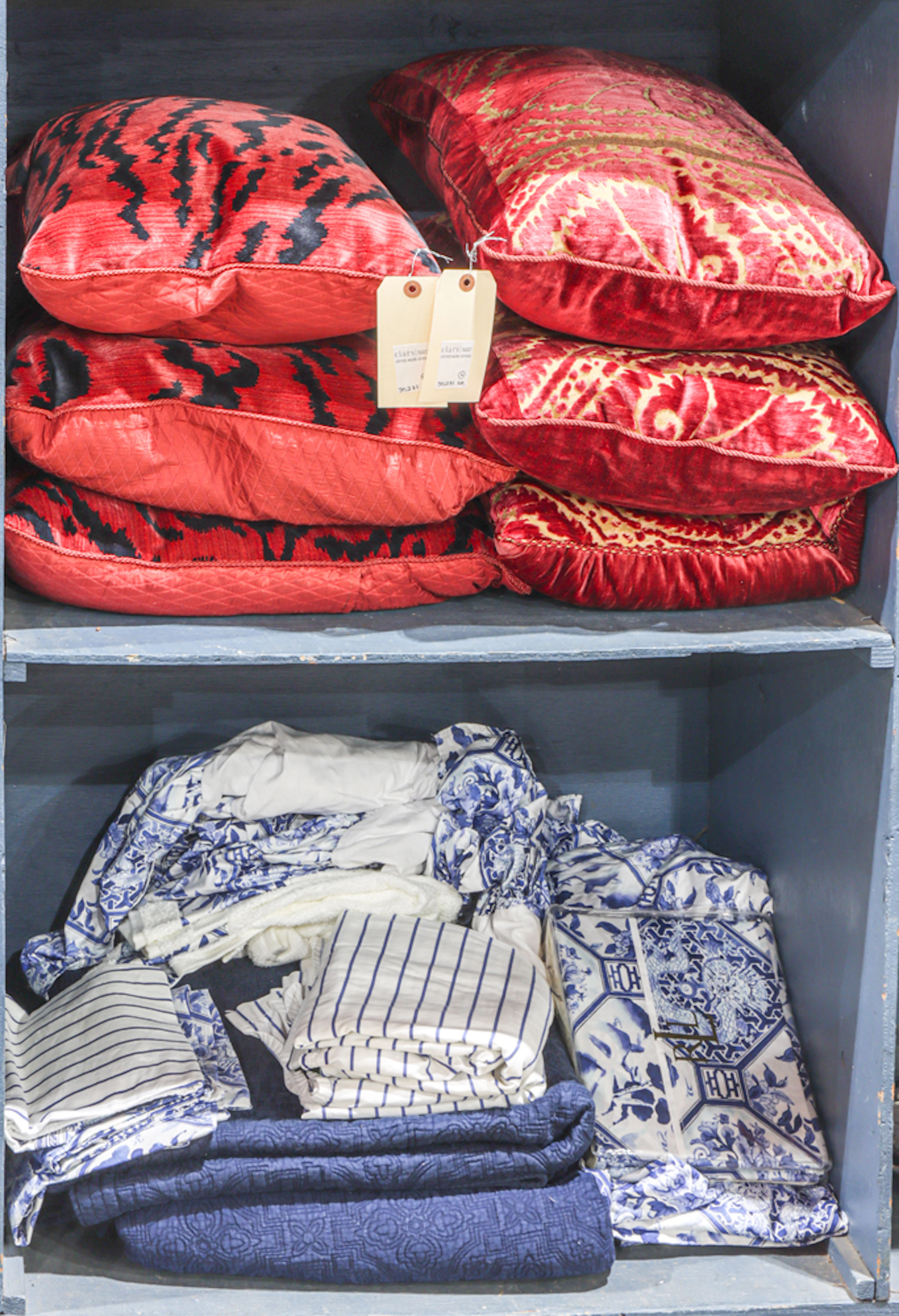 A group of animal print pillows with Ralph Lauren bed linens