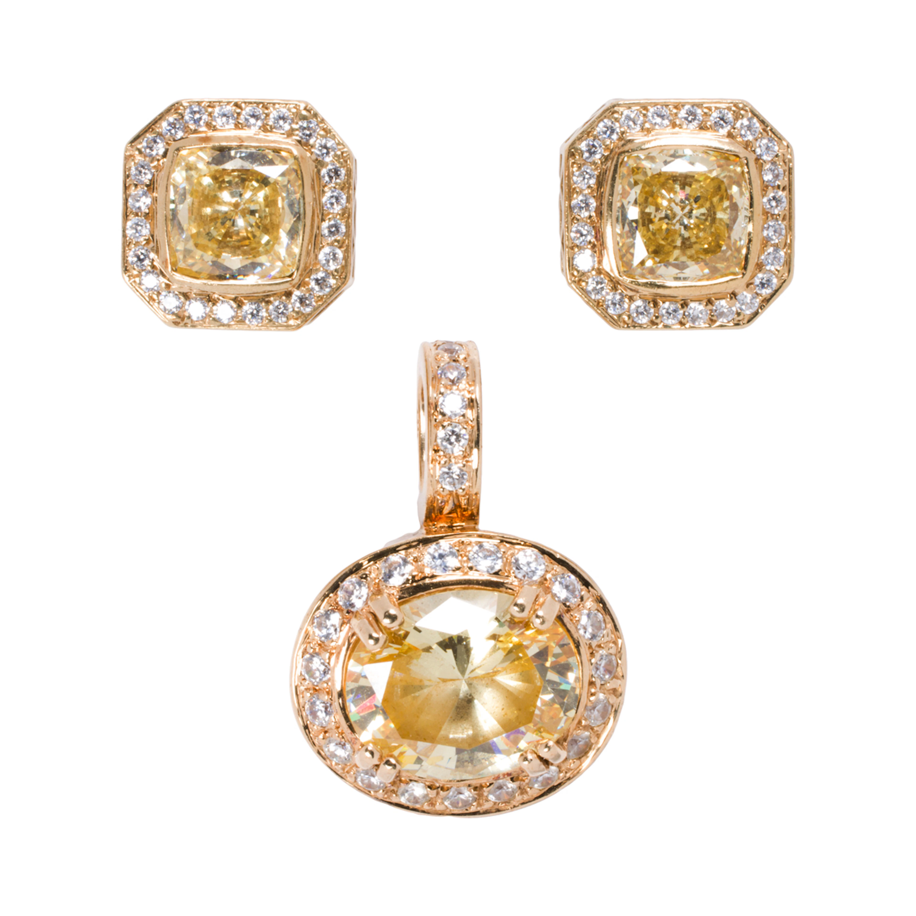 A cubic zirconia and 14k gold pendant and earring set