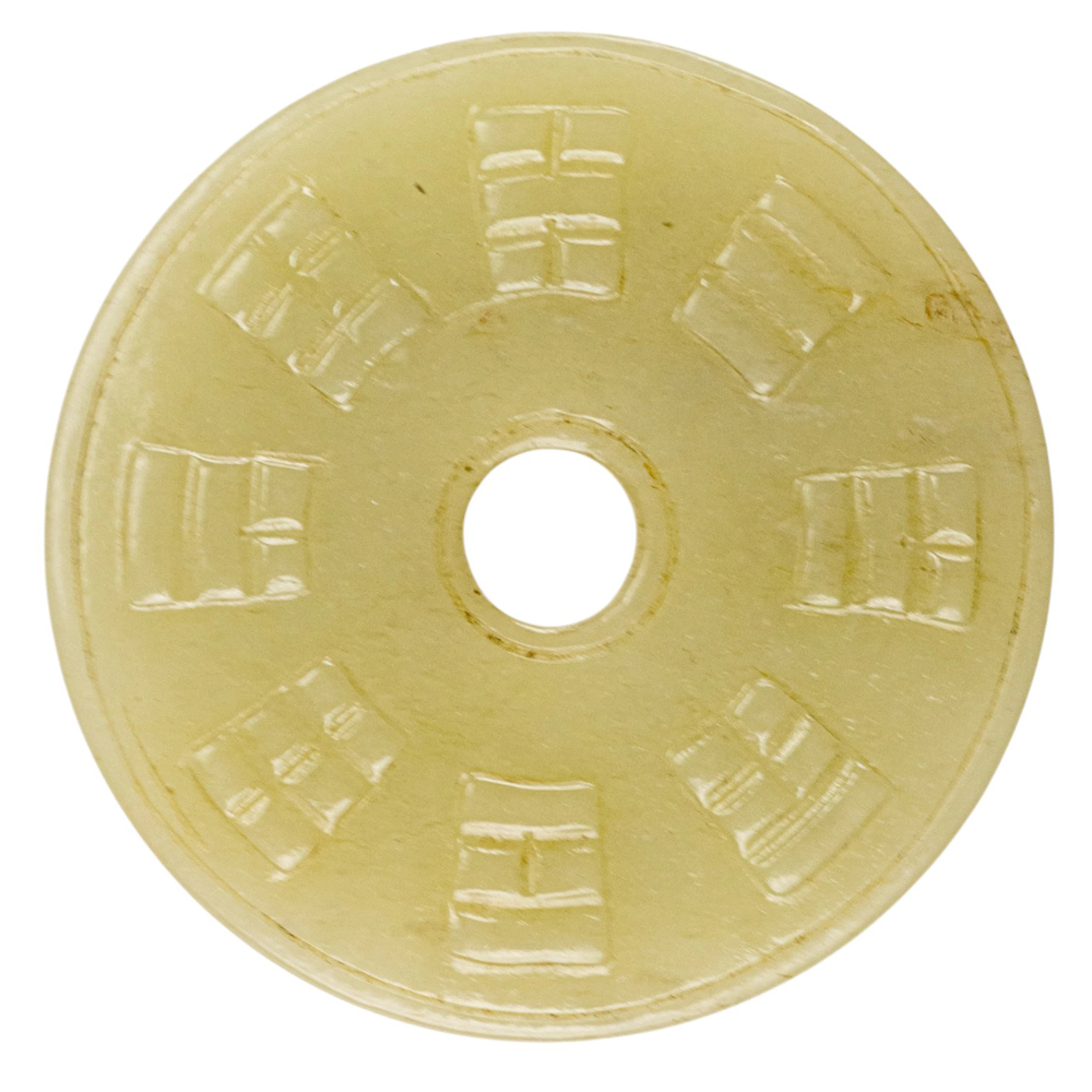A Chinese celadon jade 'trigram' bi disc