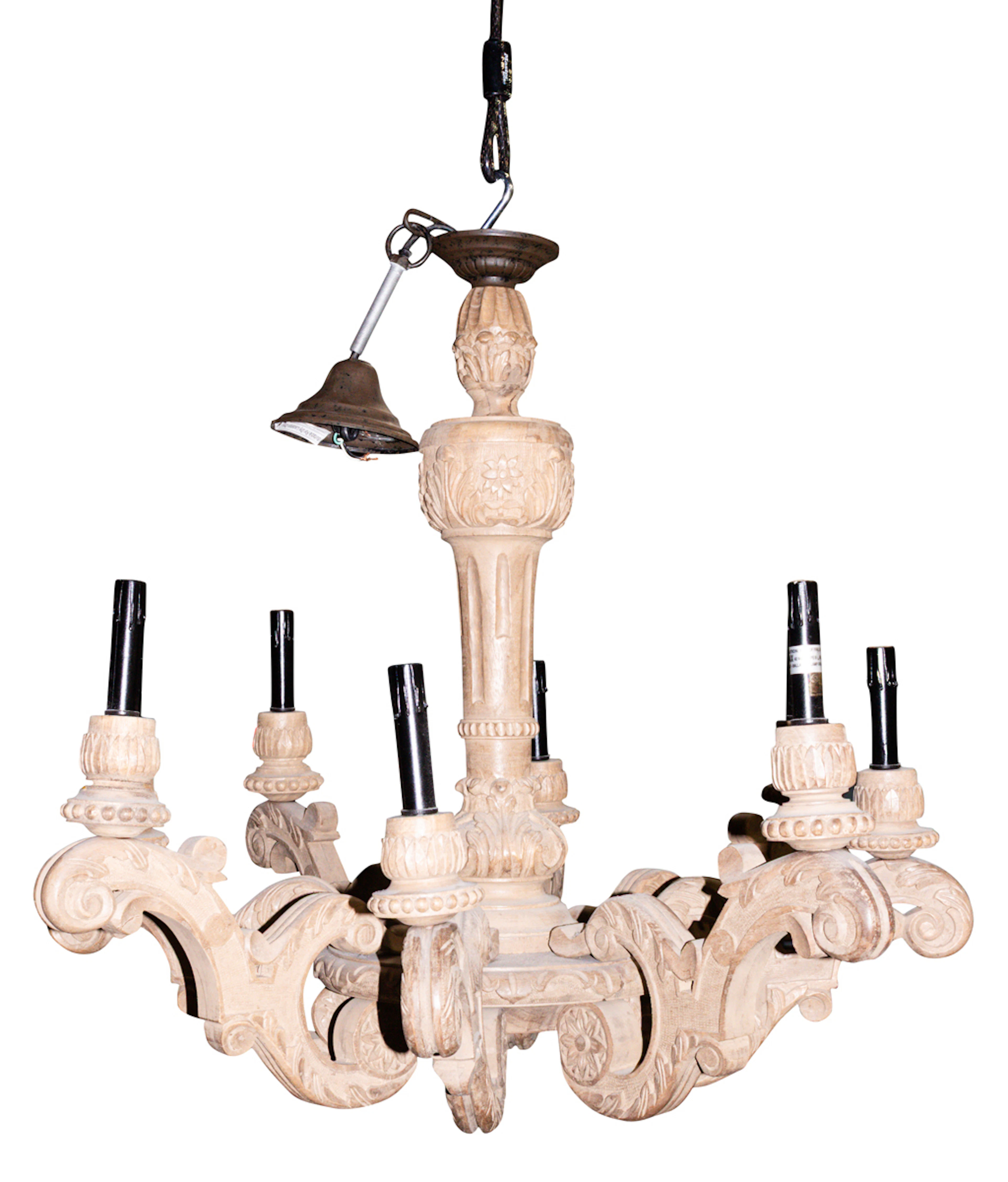 A Provincial style carved wood eight-light chandelier