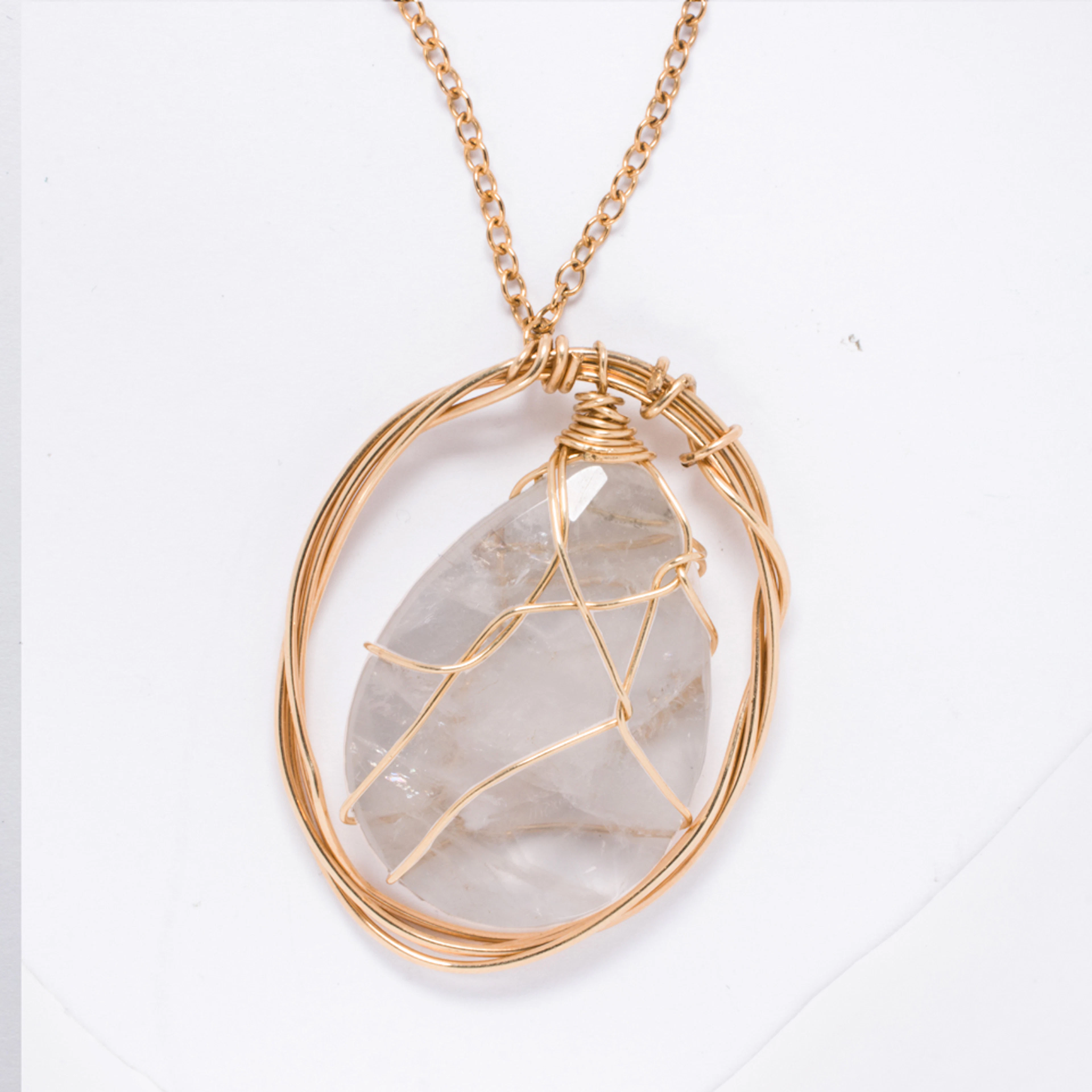 A moonstone and 18k gold pendant necklace