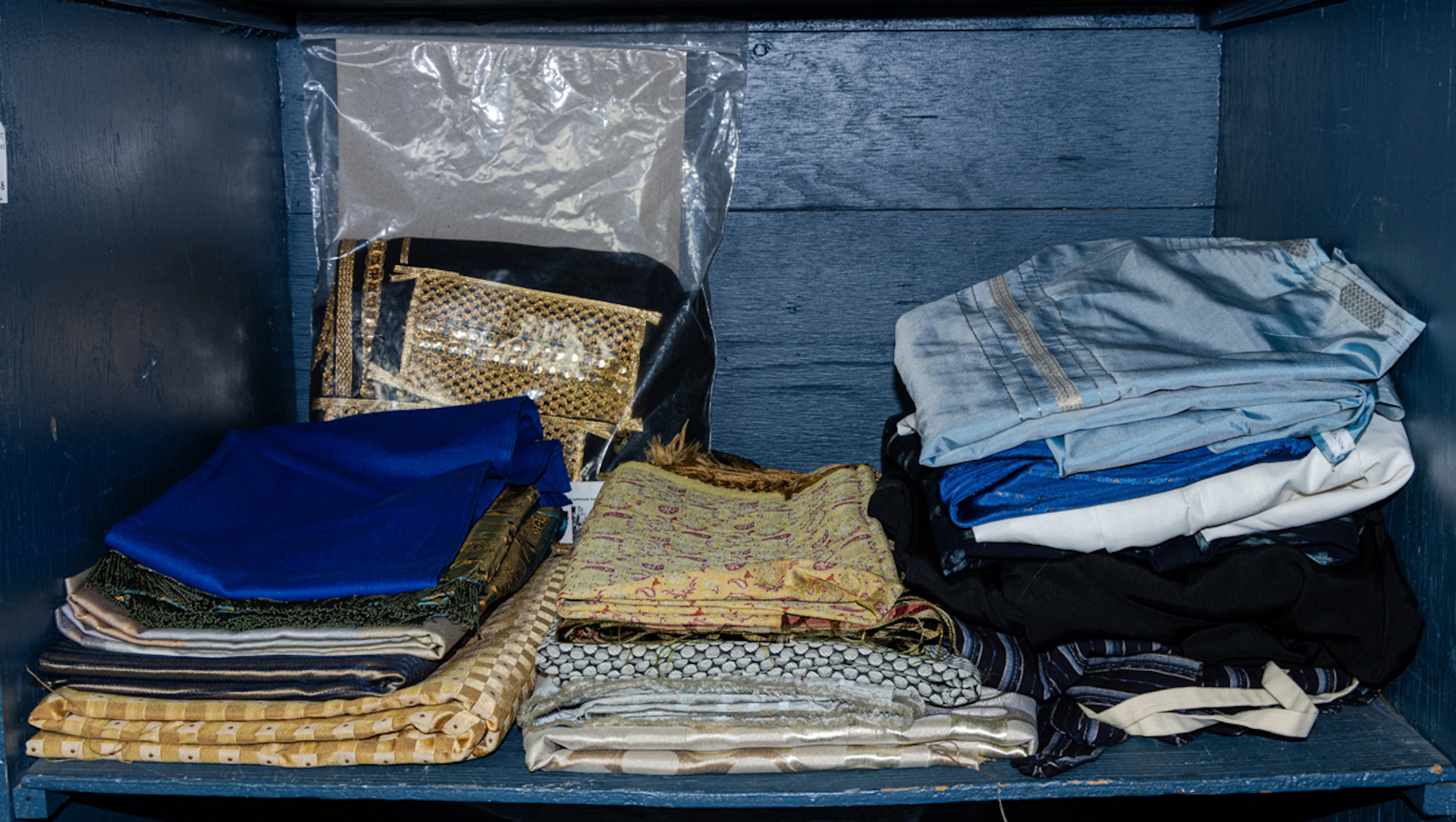A collection of various fabrics and clothing items