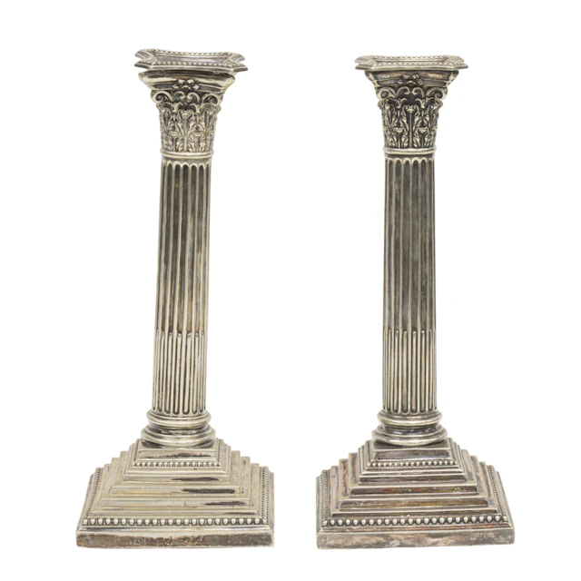 An English silver plated pair of Corinthian column candlesticks