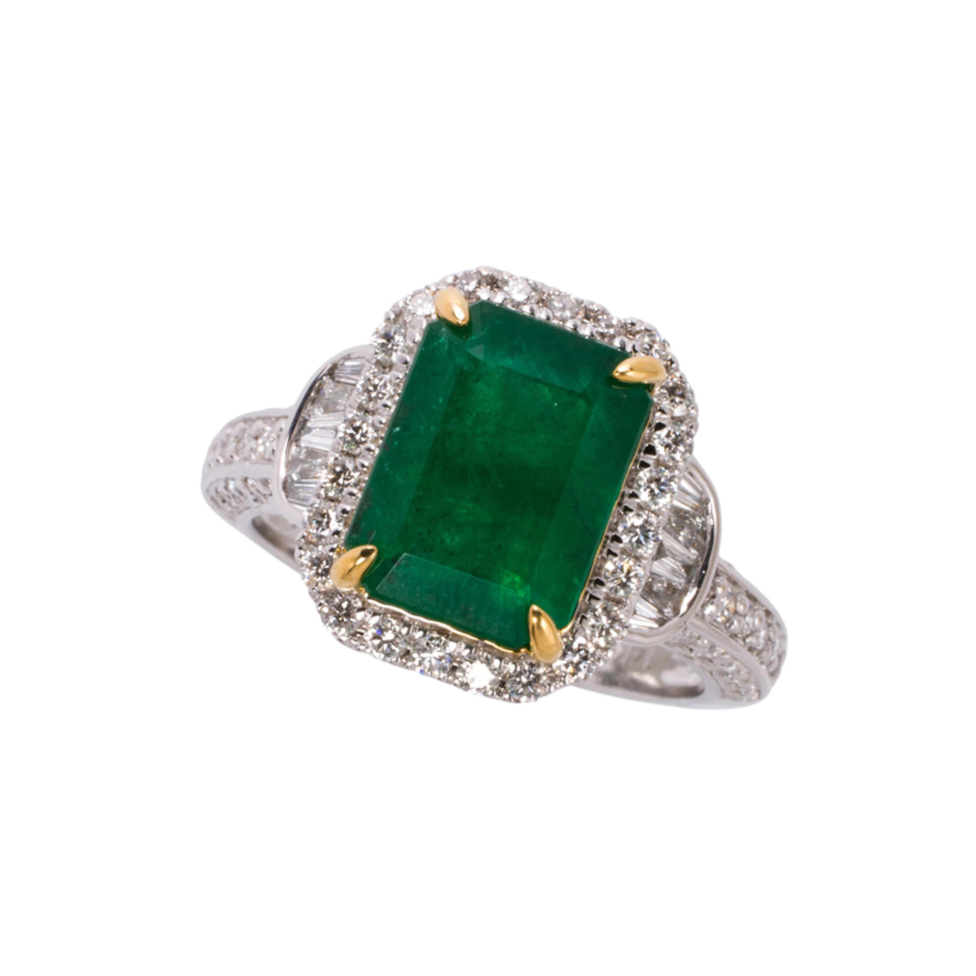 An emerald, diamond, and 14k white gold ring