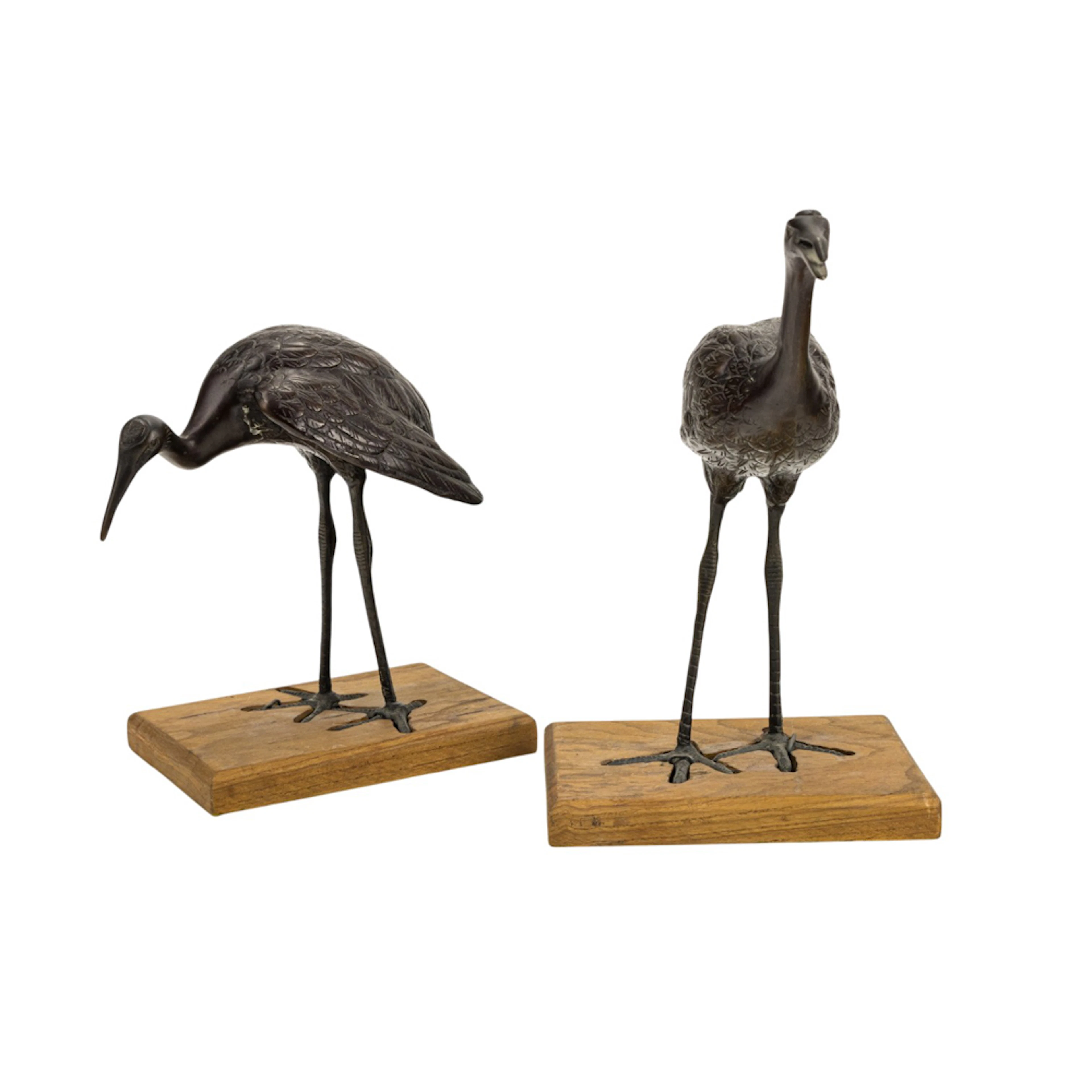 A pair of Japanese patinated bronze crane figures