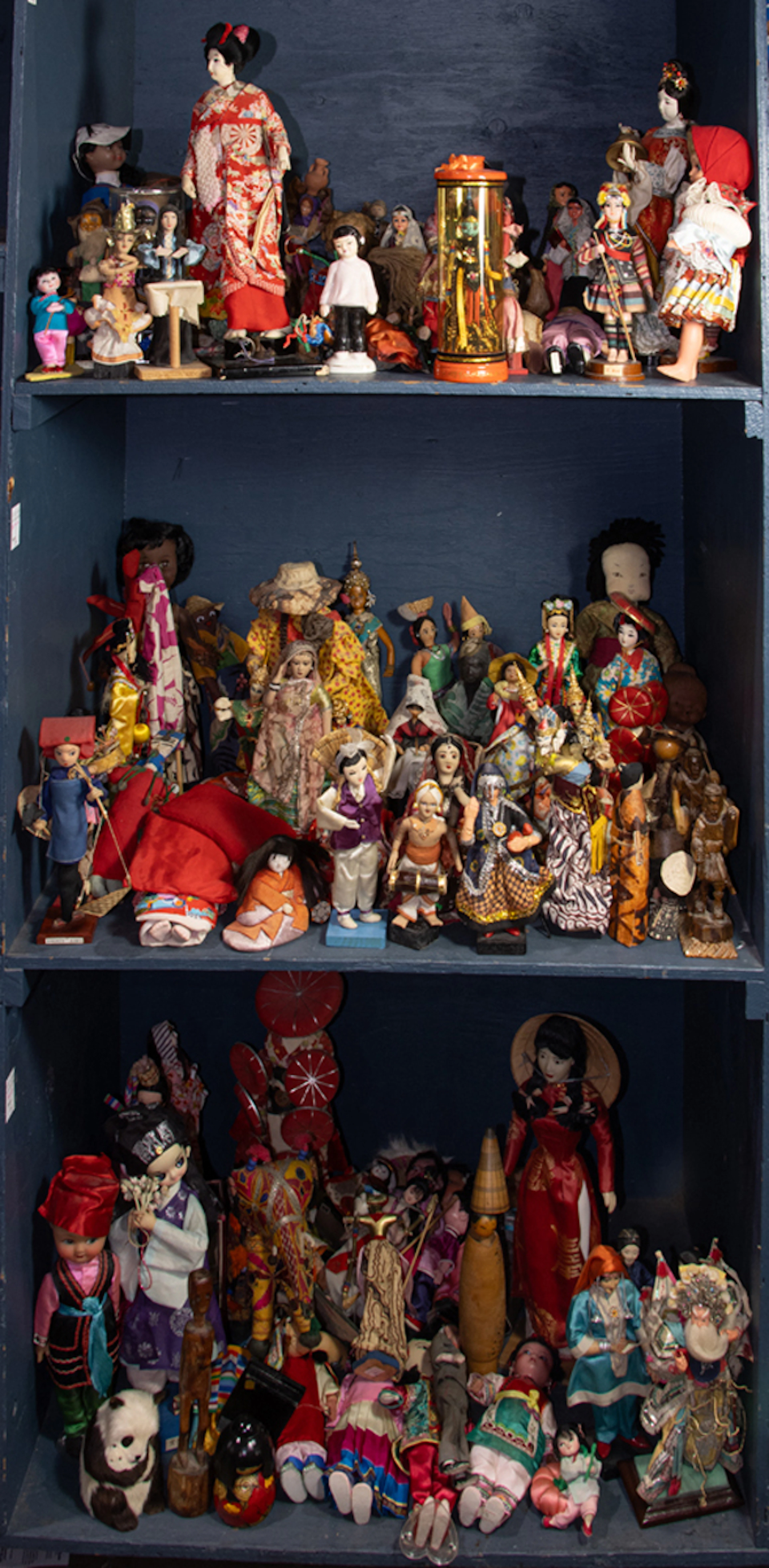 An assembled group of dolls mainly of people from the Asian continent