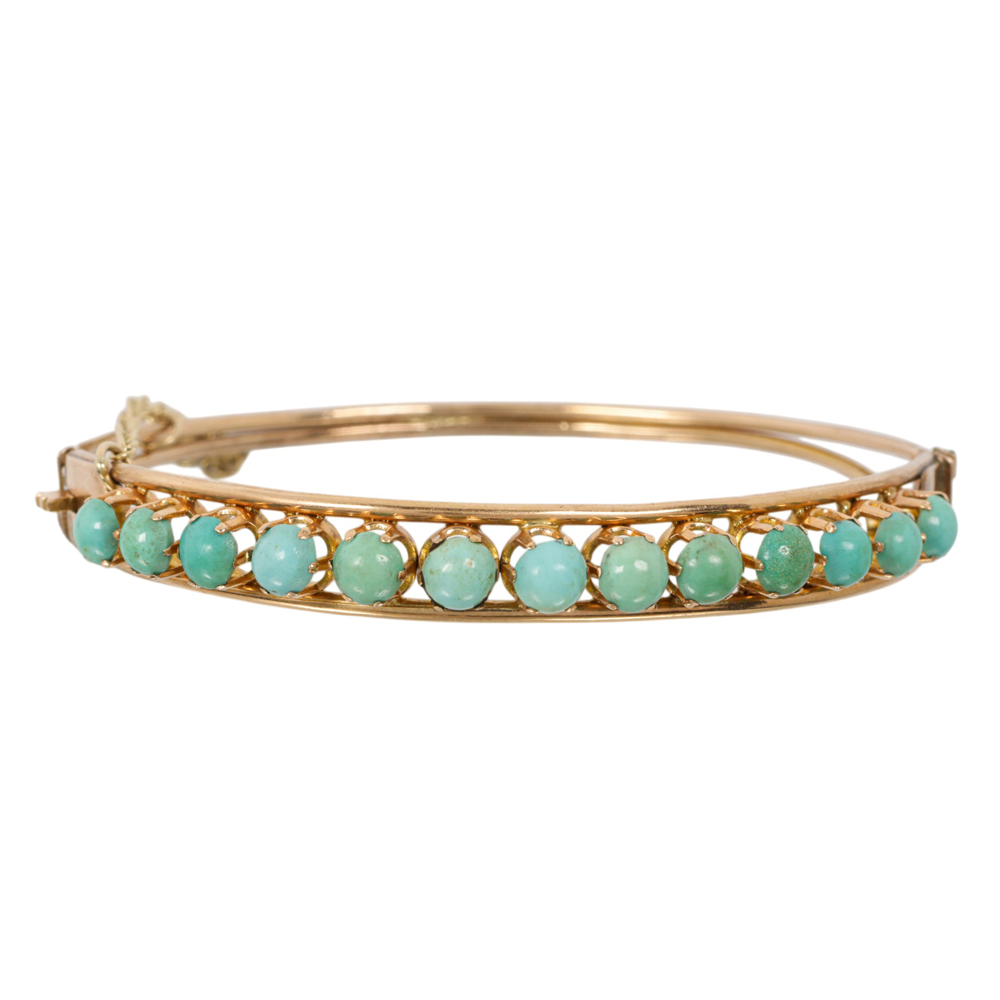 An antique turquoise and 14k gold bangle bracelet