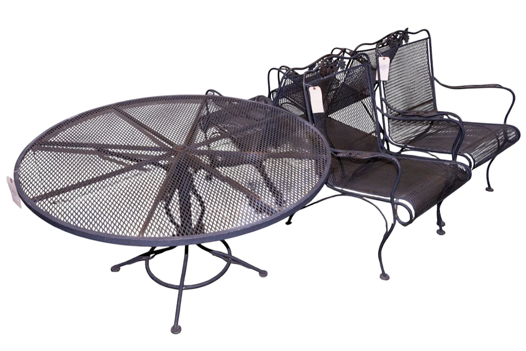 A five-piece wrought iron outdoor dining set