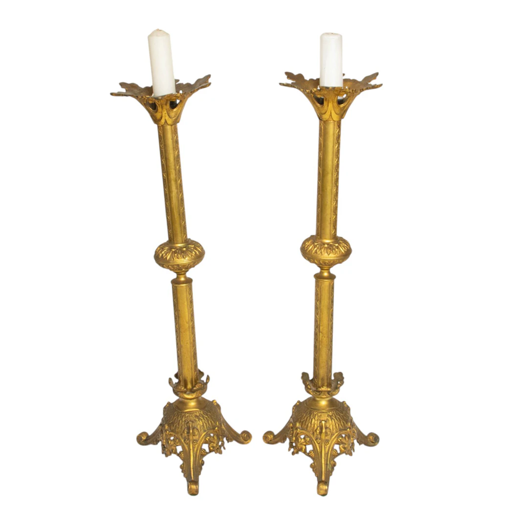 A pair of Gothic Revival style gilt metal altar candlesticks