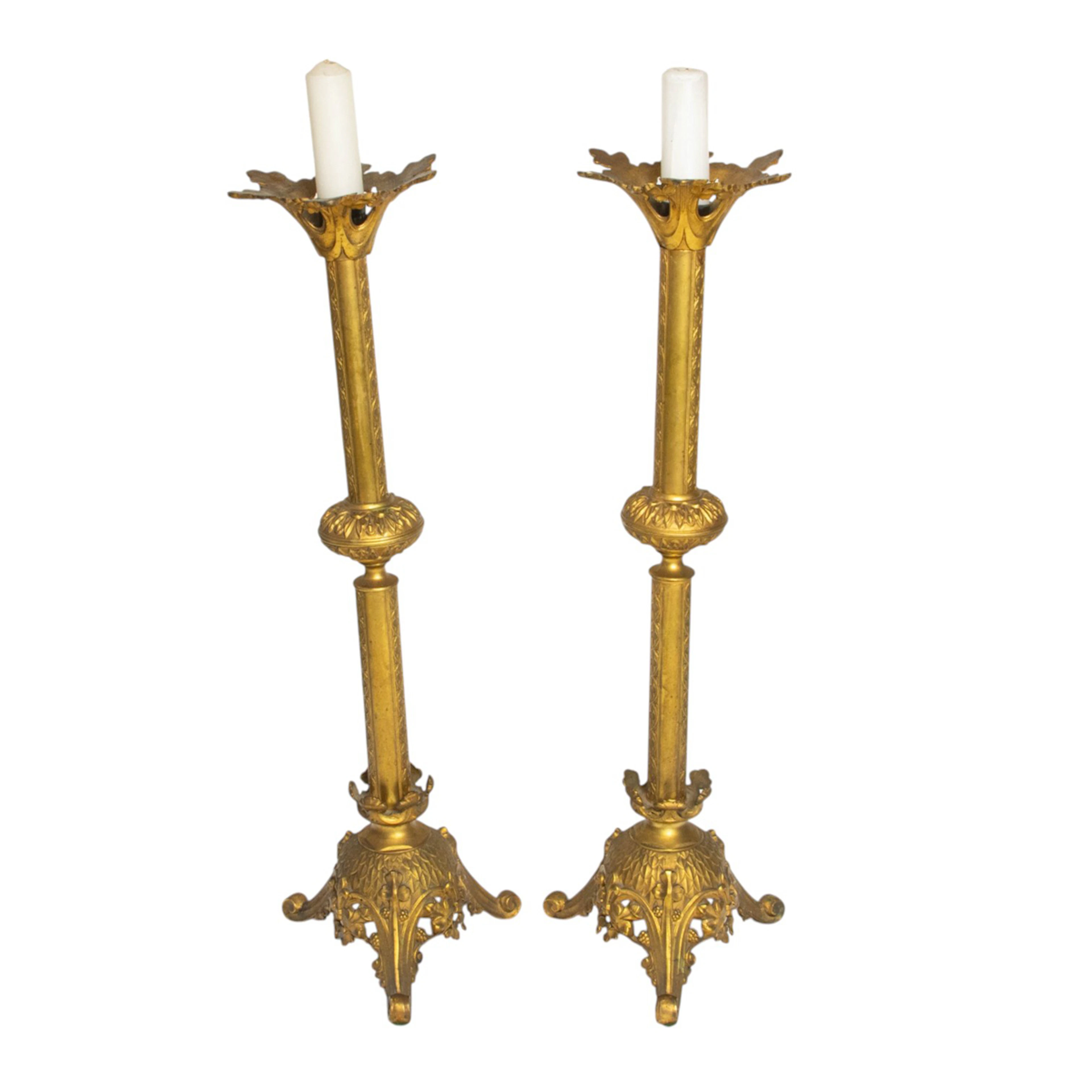 A pair of Gothic Revival style gilt metal altar candlesticks