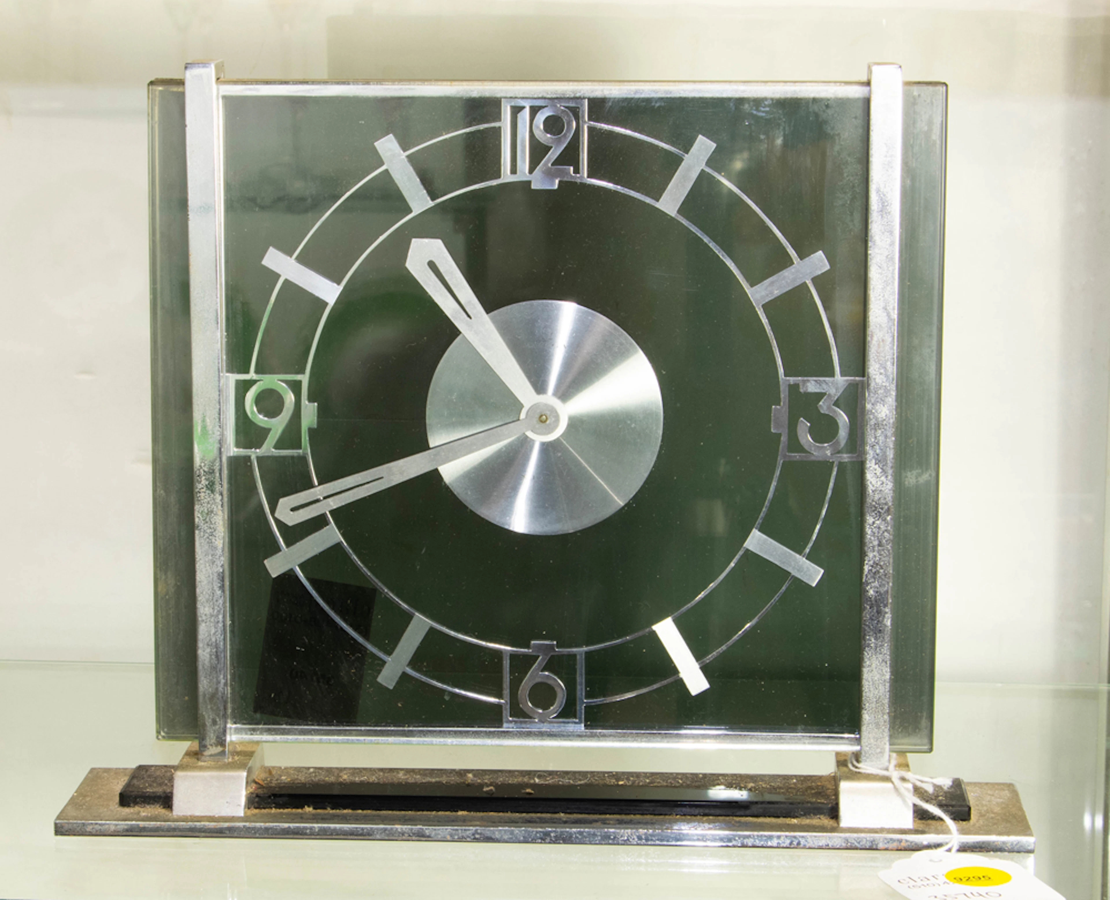 An Art Deco chromed metal and glass eight-day shelf clock