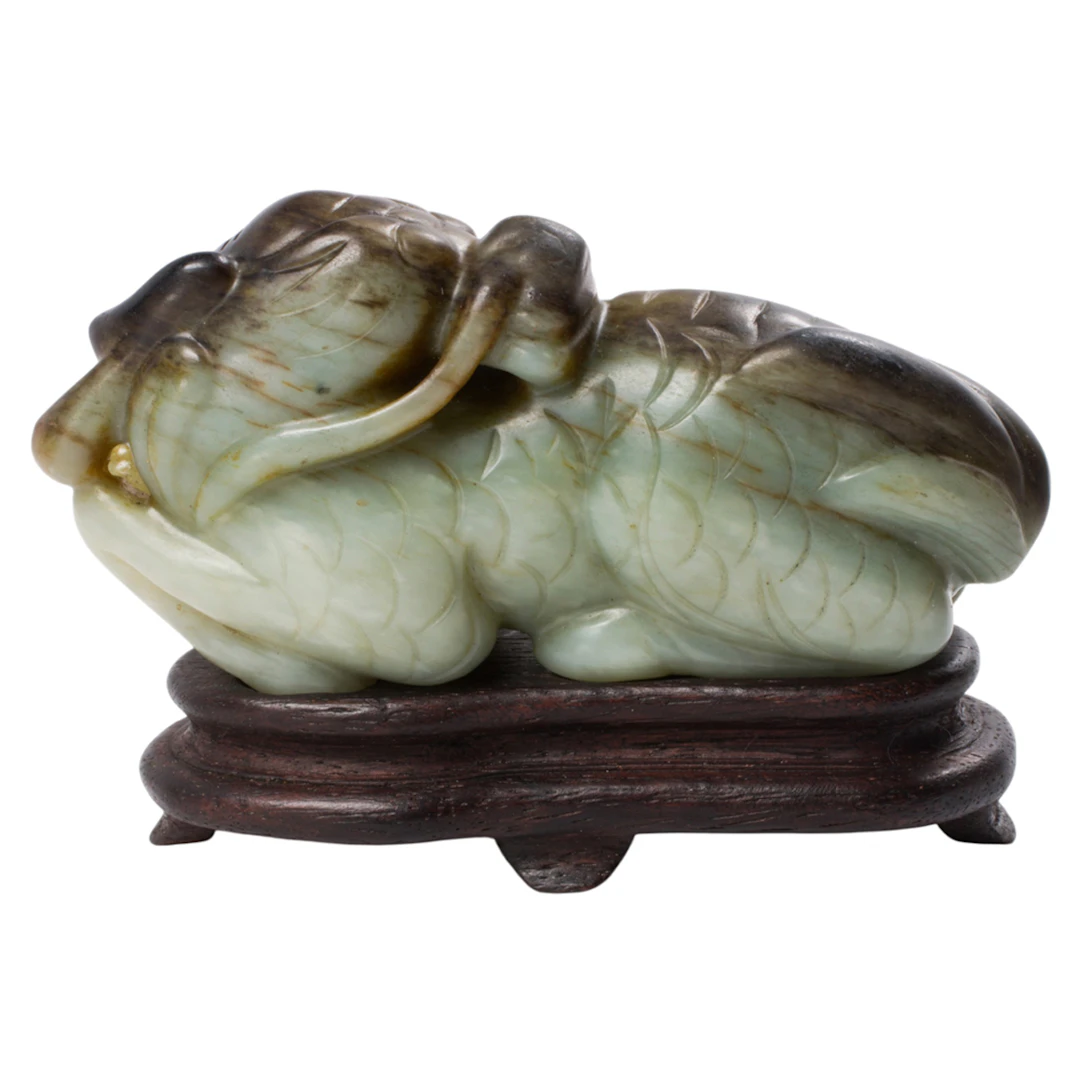 A Chinese mottled celadon jade qilin figure