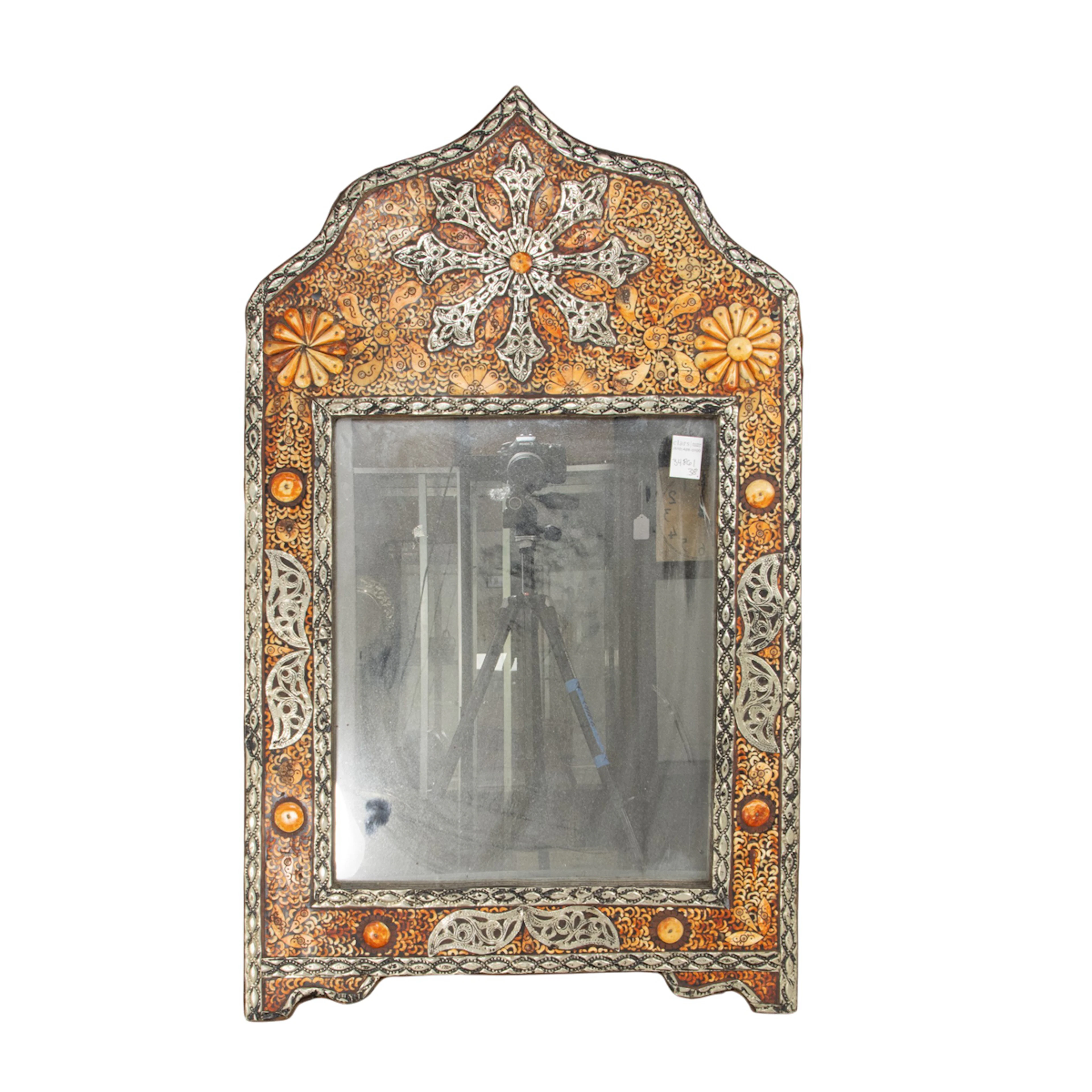 A Moroccan metal and bone mounted arched mirror