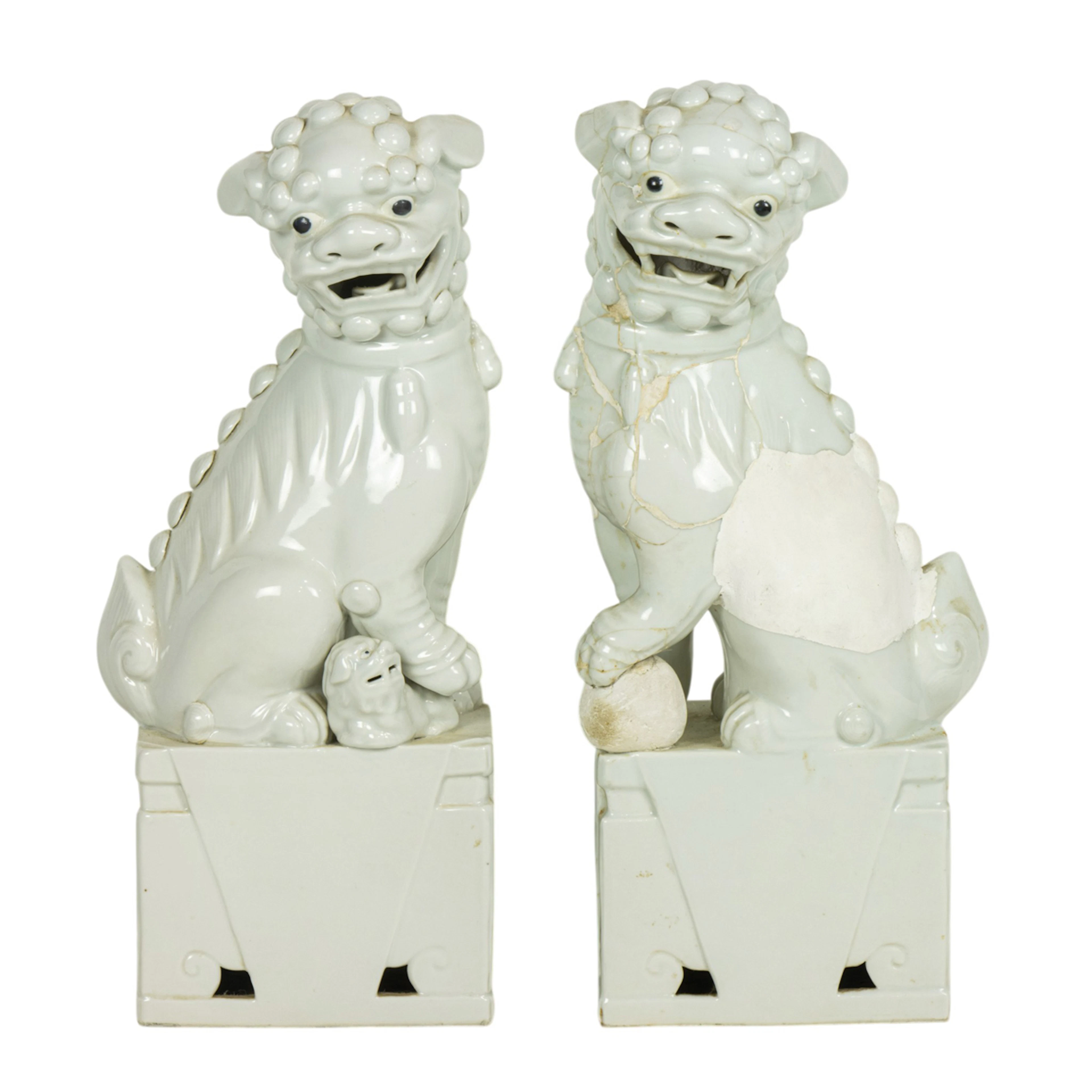 A pair of Chinese white glazed food dog figures