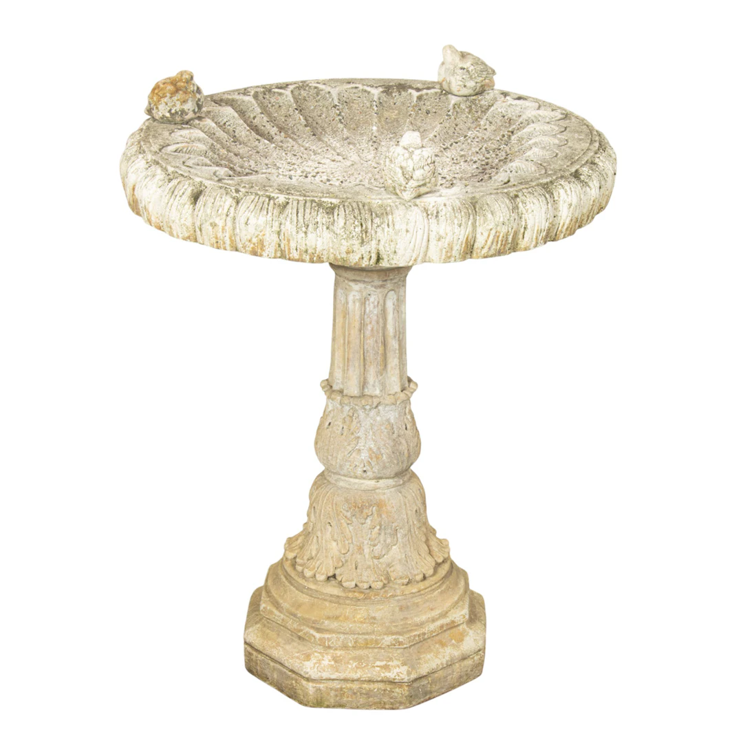 A cast stone bird bath