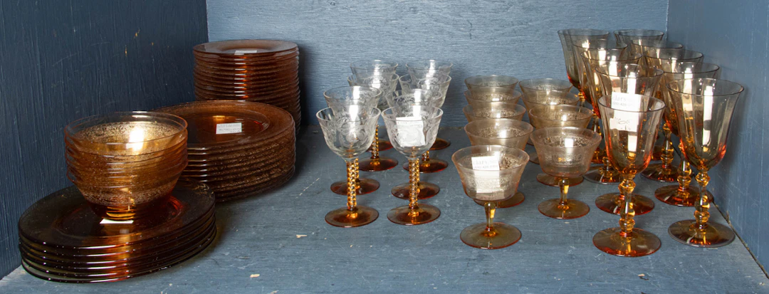 An assembled Tiffin and Fostoria amber and clear glass suite of stemware
