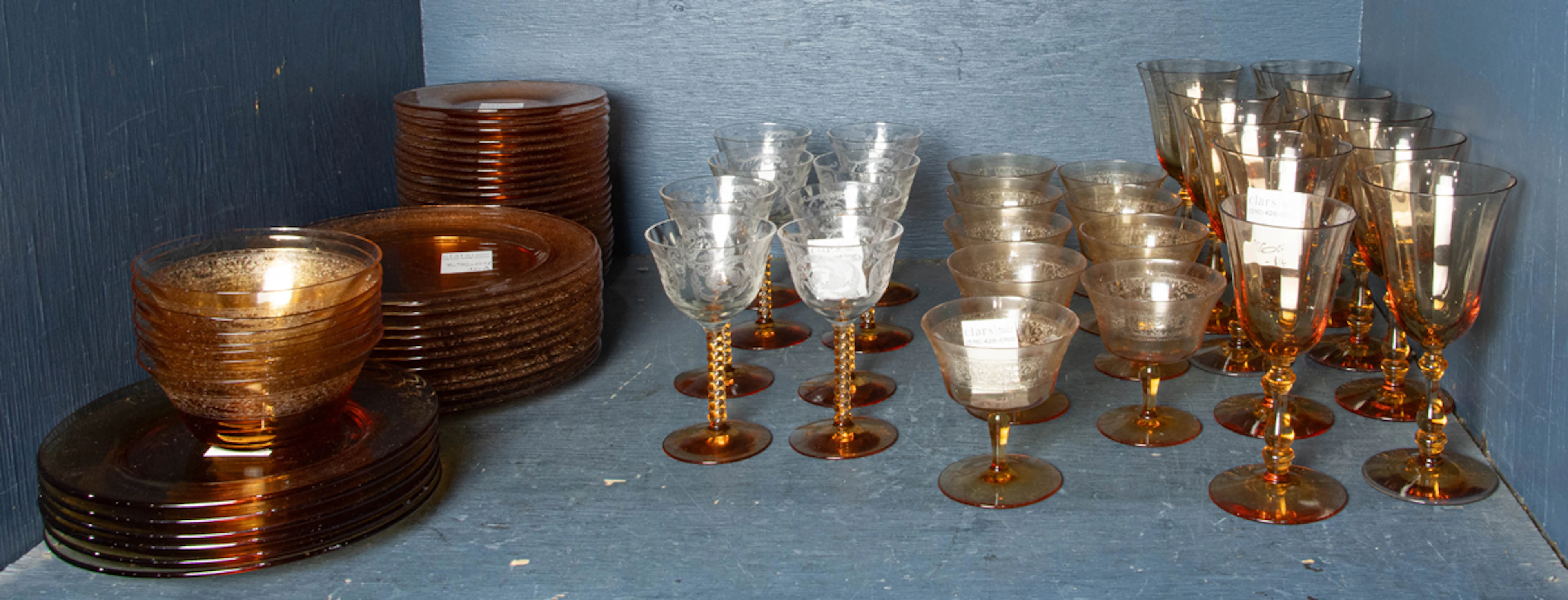 An assembled Tiffin and Fostoria amber and clear glass suite of stemware