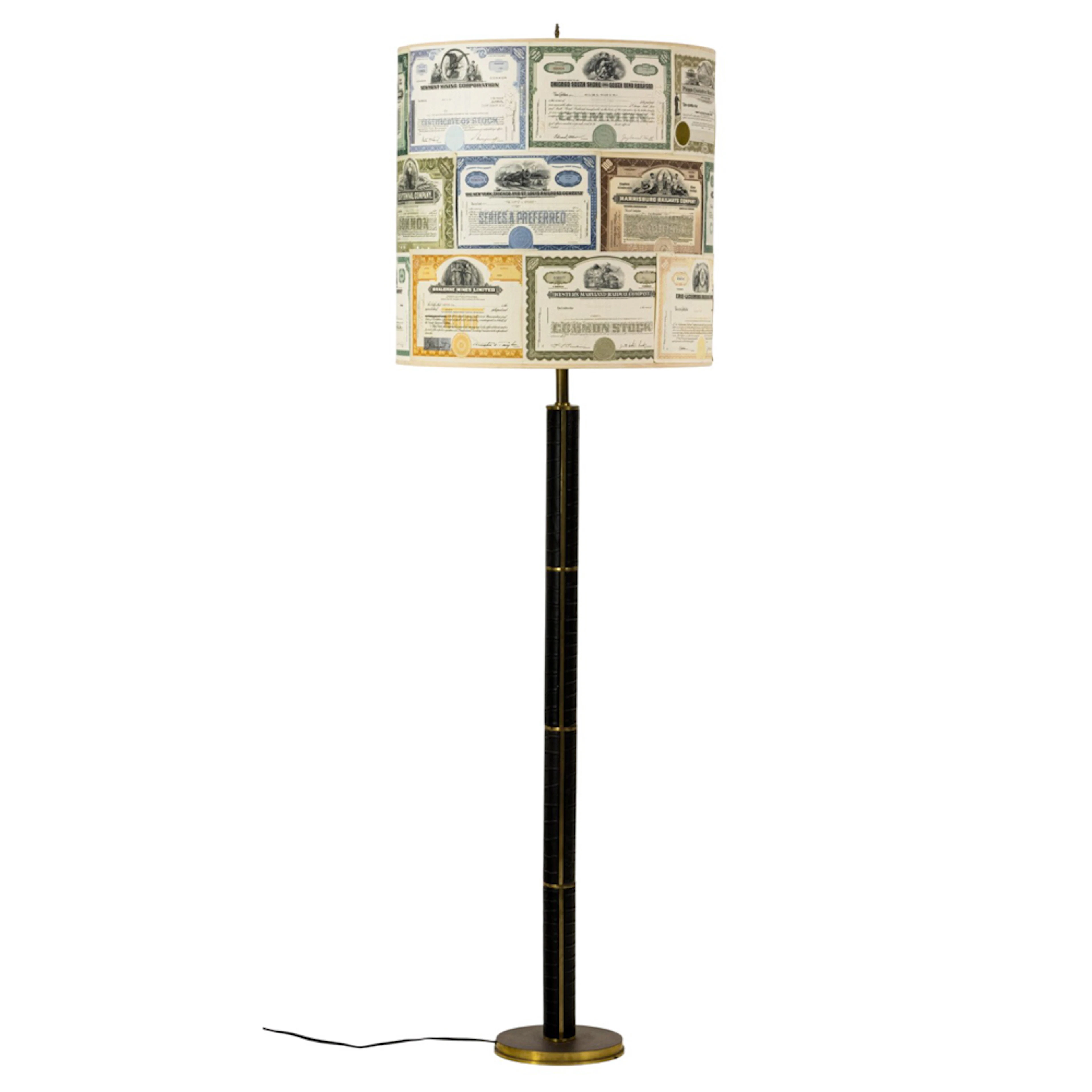 A leather clad floor lamp with custom stock certificate shade